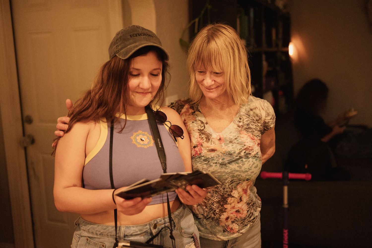 Two people sharing a warm moment in dim lighting at an indoor gathering.