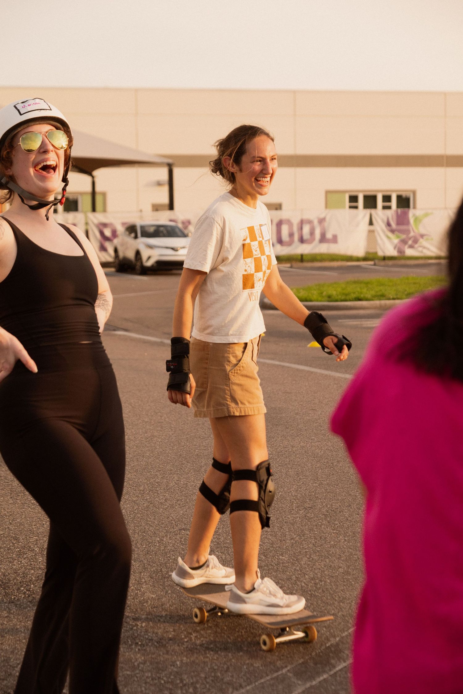 Group skateboarding session in a parking lot with people practicing tricks together.
