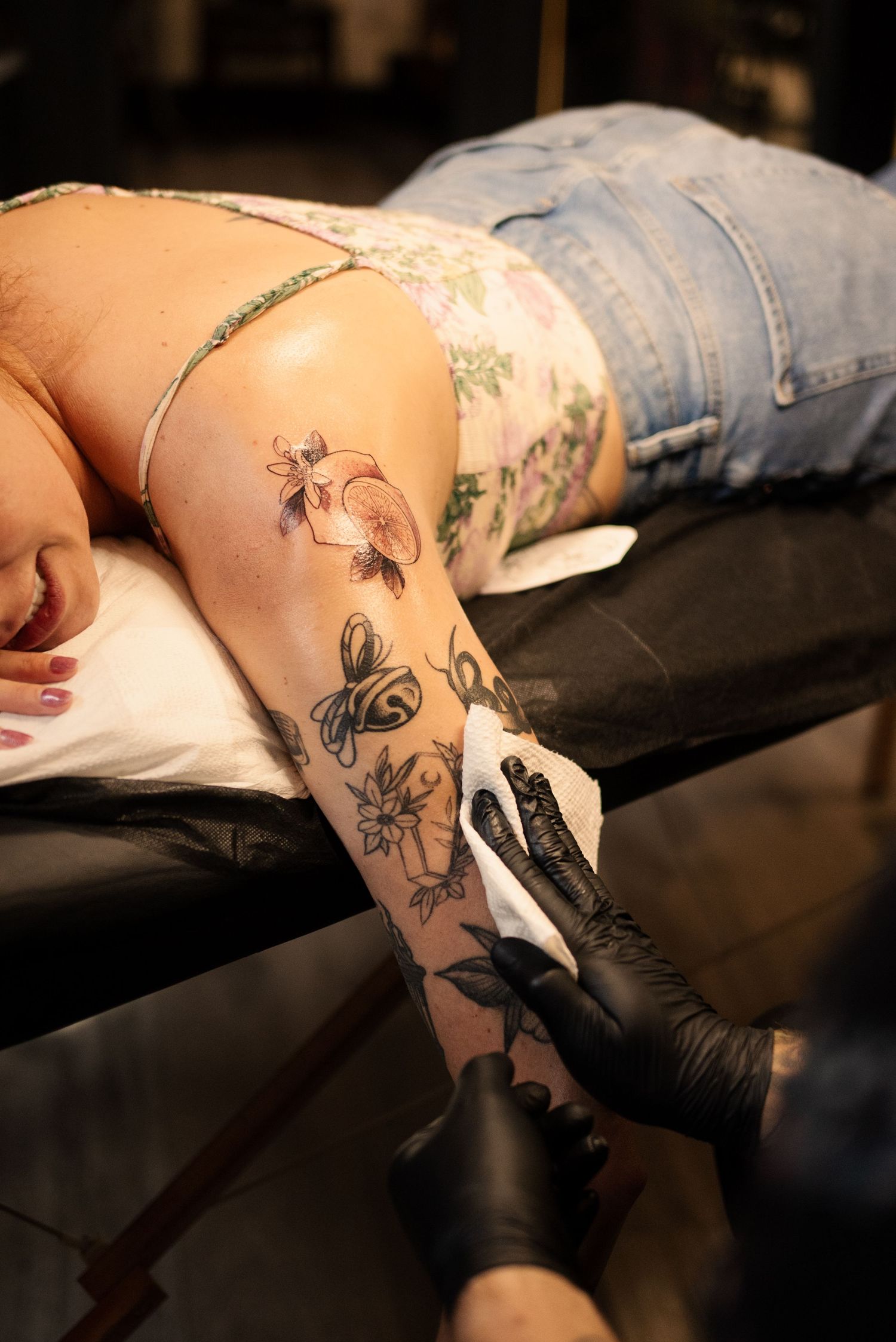 Close-up of floral and nature-themed tattoo work in progress on skin.