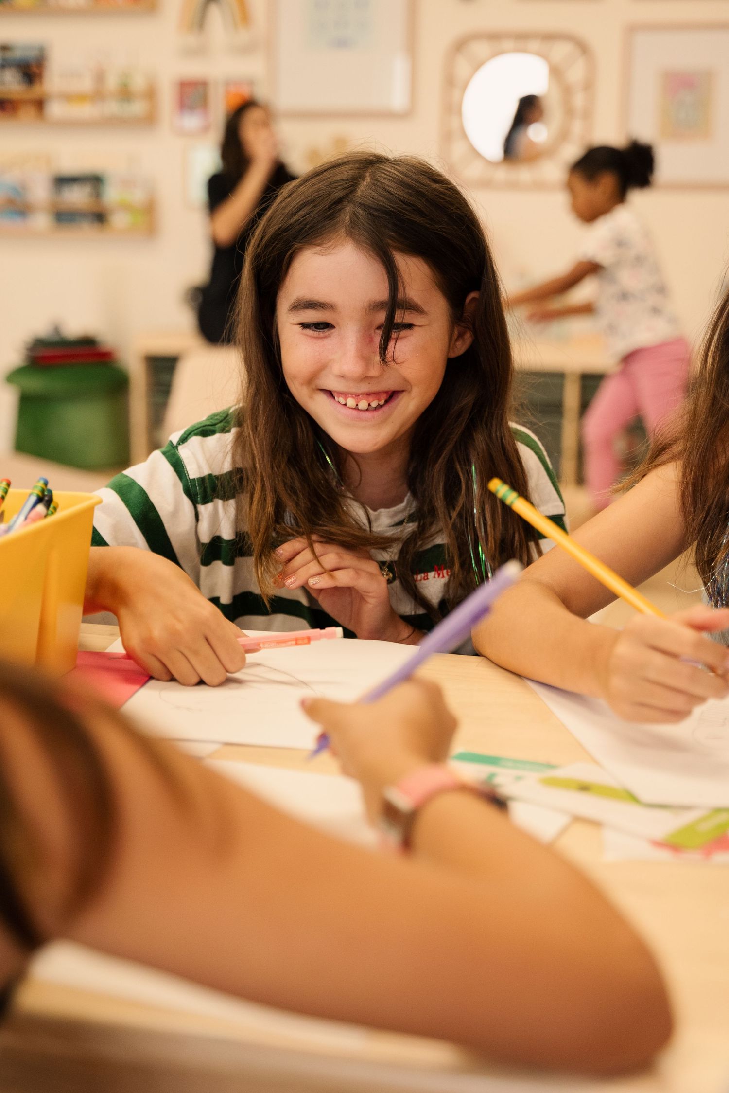 Students participating in a creative writing activity at a table.