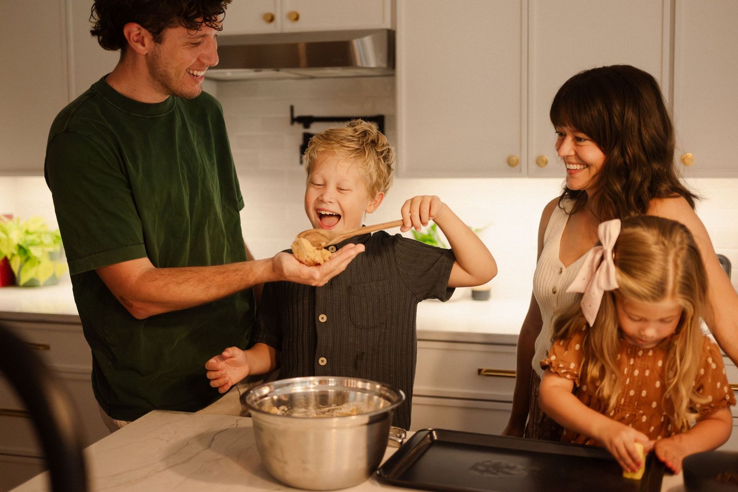 Family baking together in a bright modern kitchen.