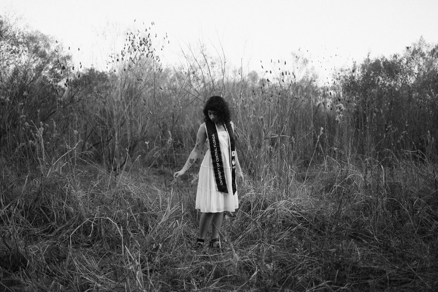 A series of black and white outdoor portrait shots in a natural setting.