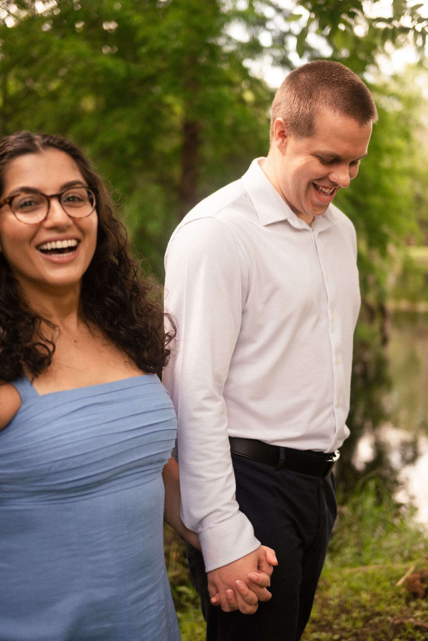 Candid moments of laughter shared between two people in a sunlit garden setting.