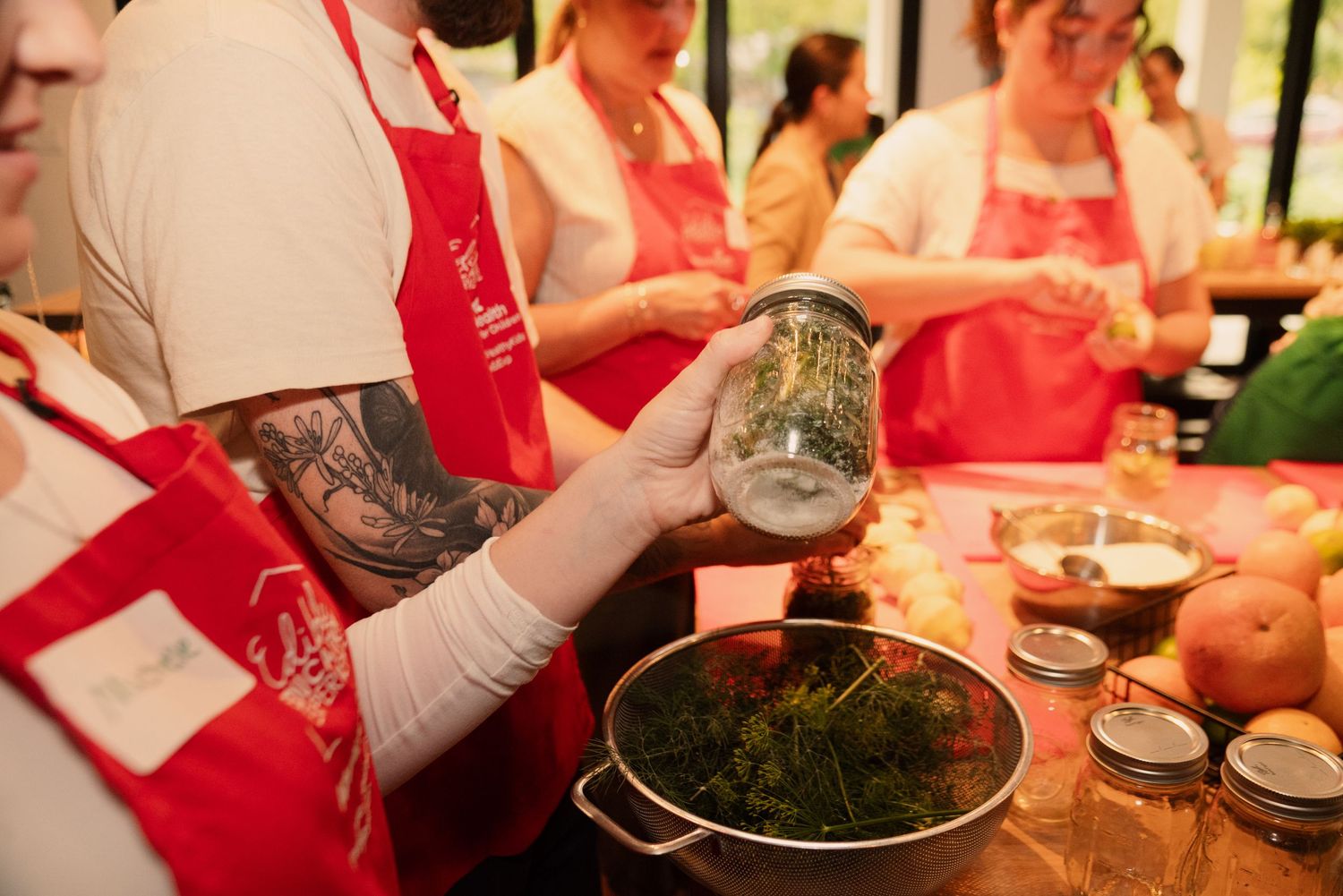 Hands chopping and preparing ingredients during a cooking demonstration.