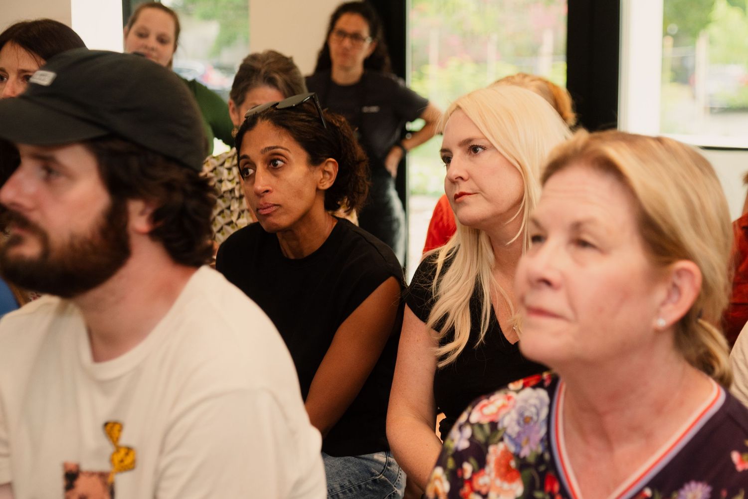 Diverse crowd of attendees watching intently during an indoor educational event.