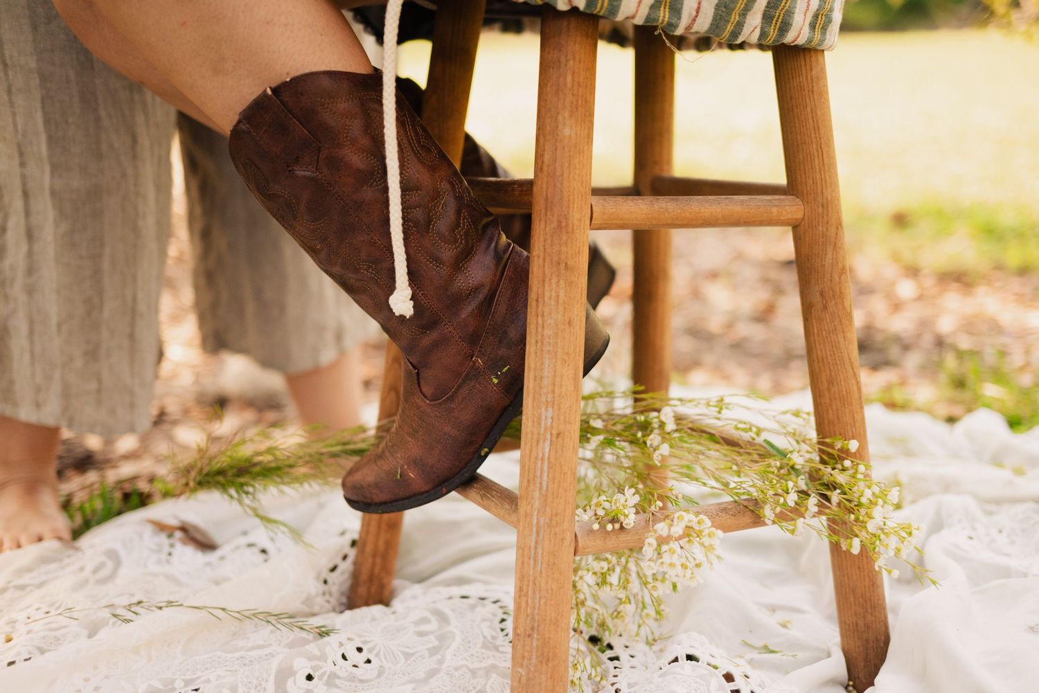 Rustic outdoor setting with white fabric and wooden furniture creating a cozy atmosphere.