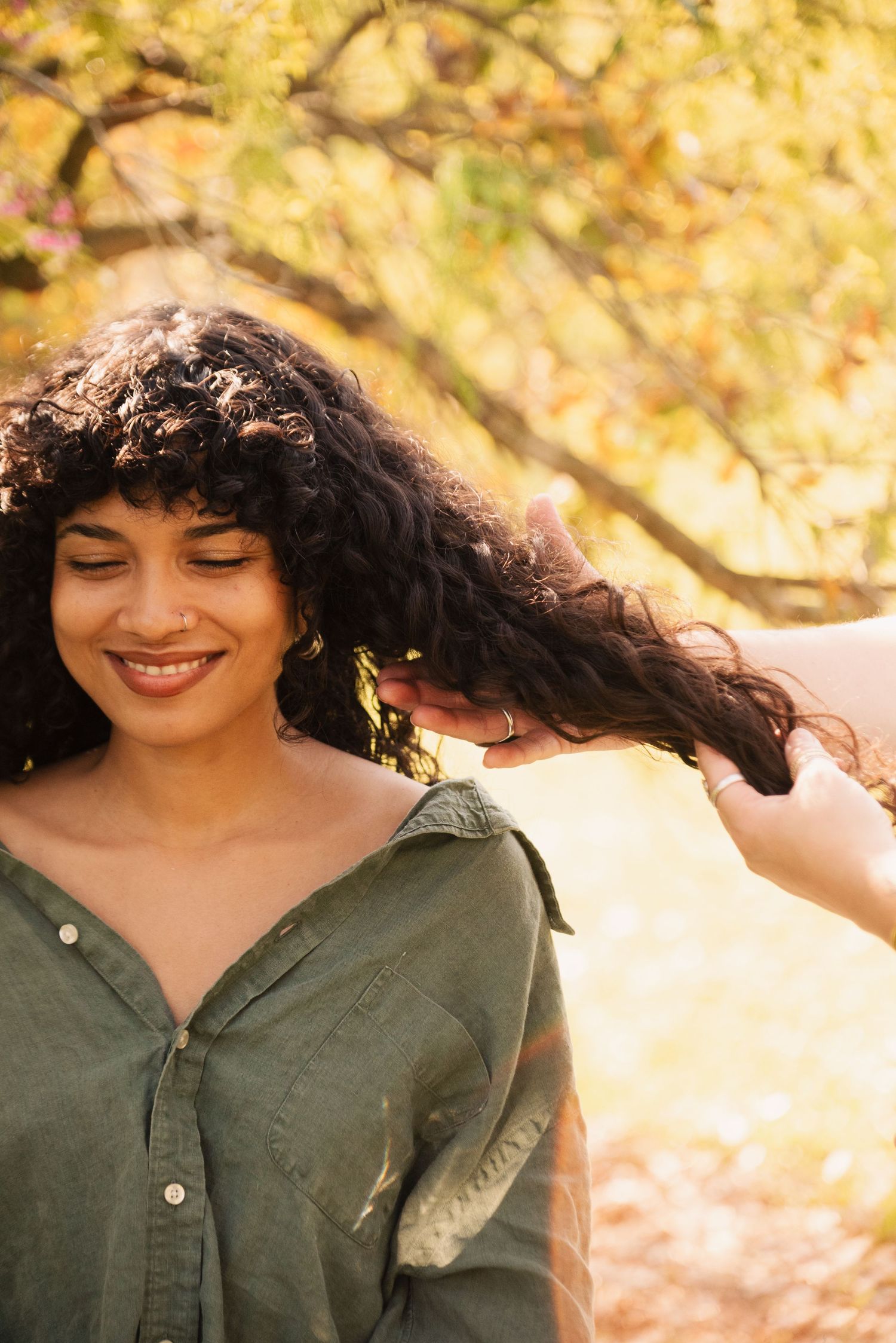 Warm autumn photoshoot featuring olive green clothing and soft golden lighting.