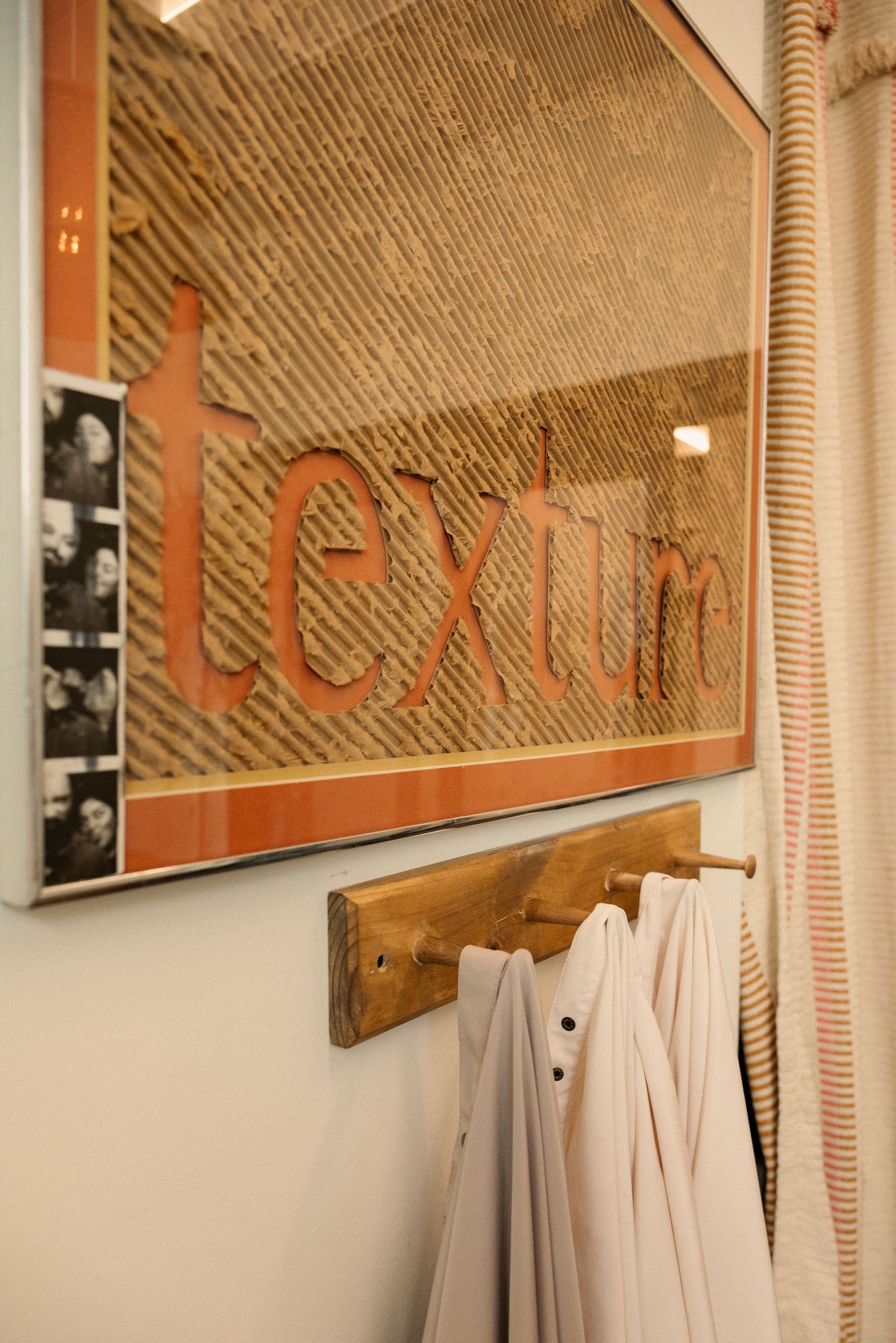A row of vintage-style mirrors mounted on a textured wall in a salon.