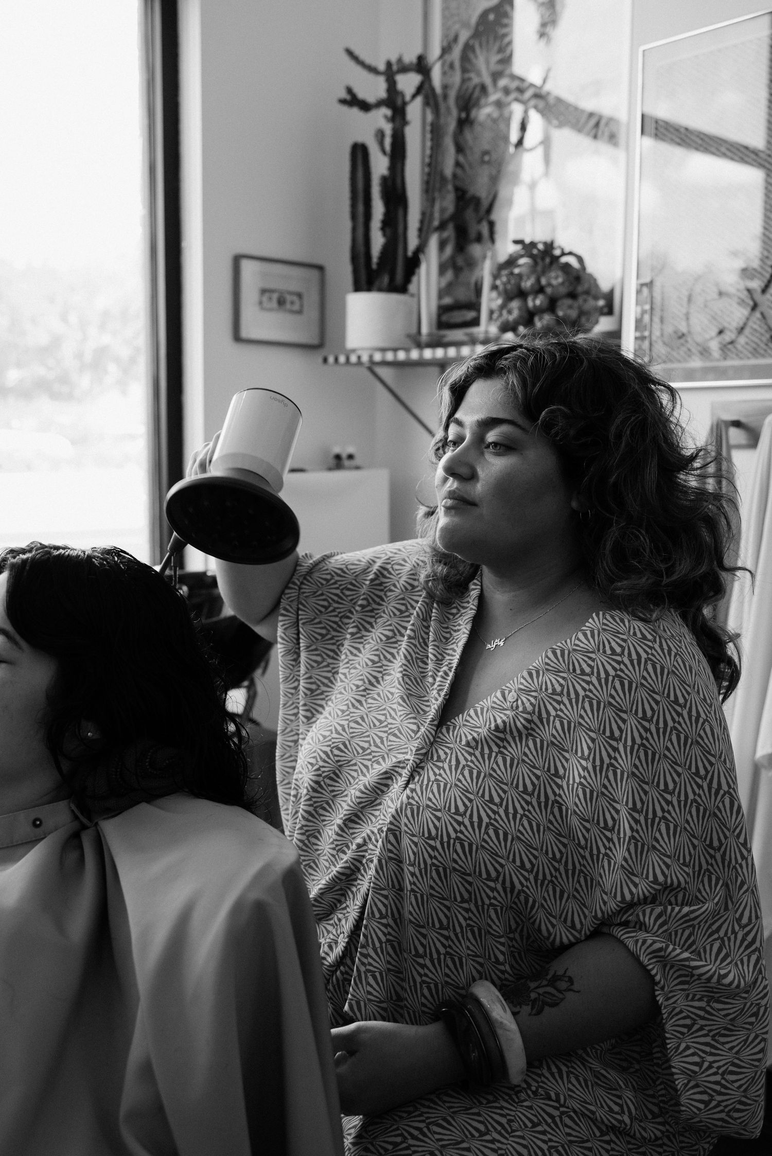 Black and white series showing relaxed moments in a salon setting.