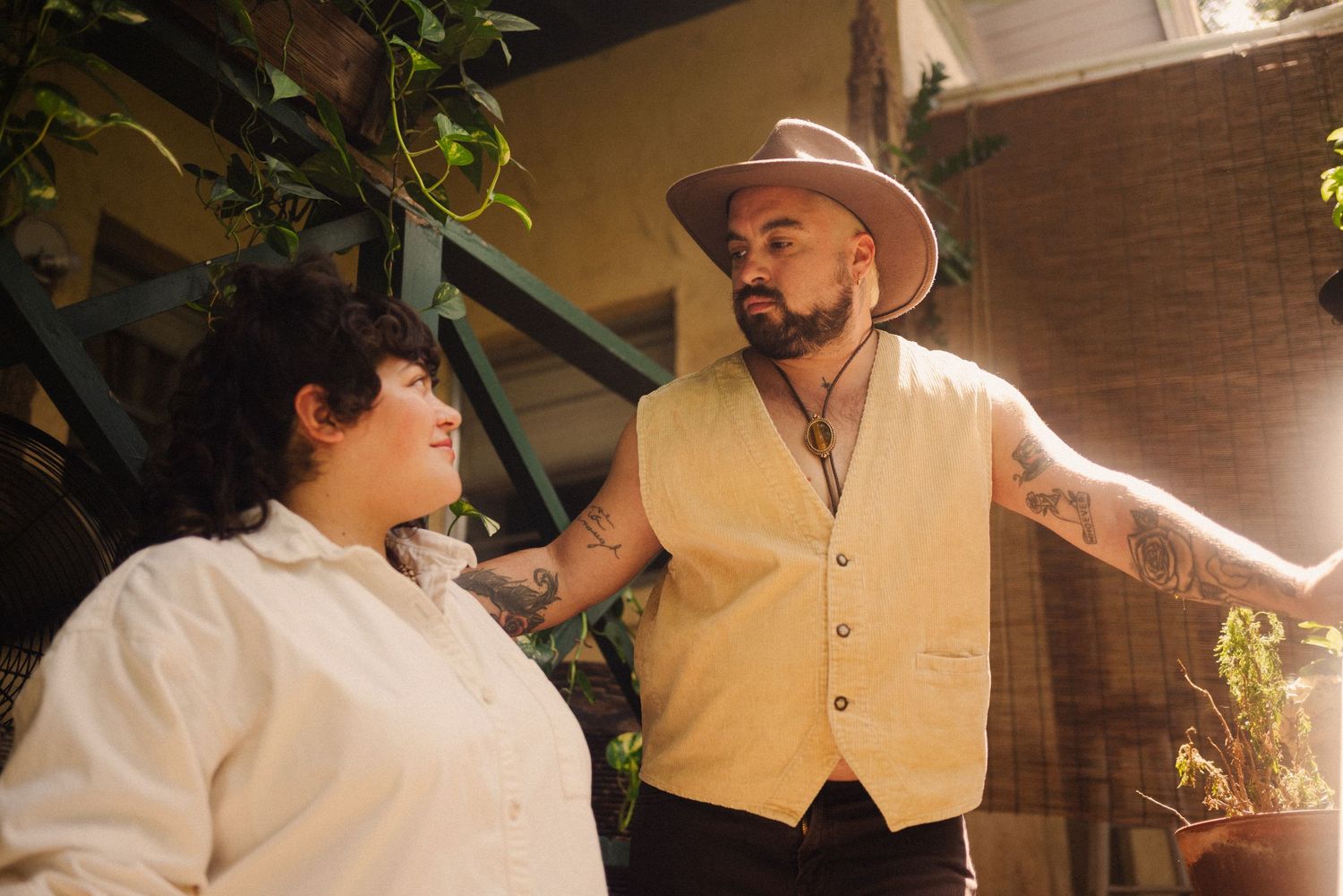 An intimate outdoor portrait session with warm lighting and garden elements.