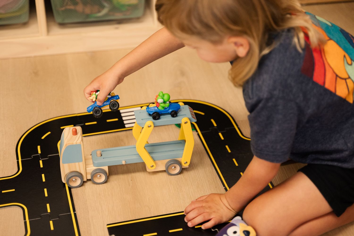 Close-up view of toy cars being played with on a road playmat.