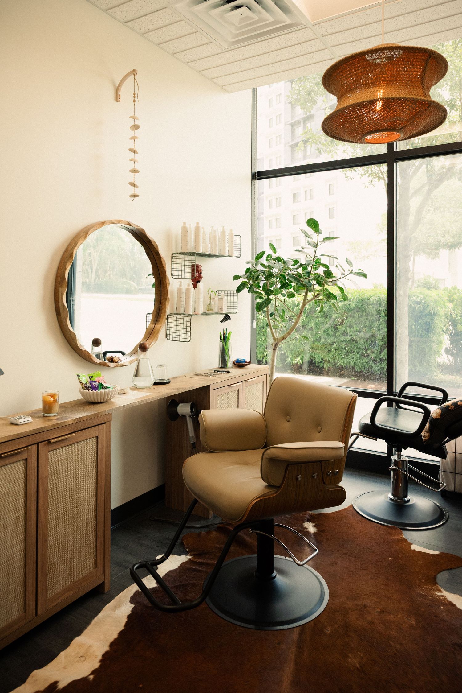 Modern salon interior with copper pendant lights and stylish salon chairs.