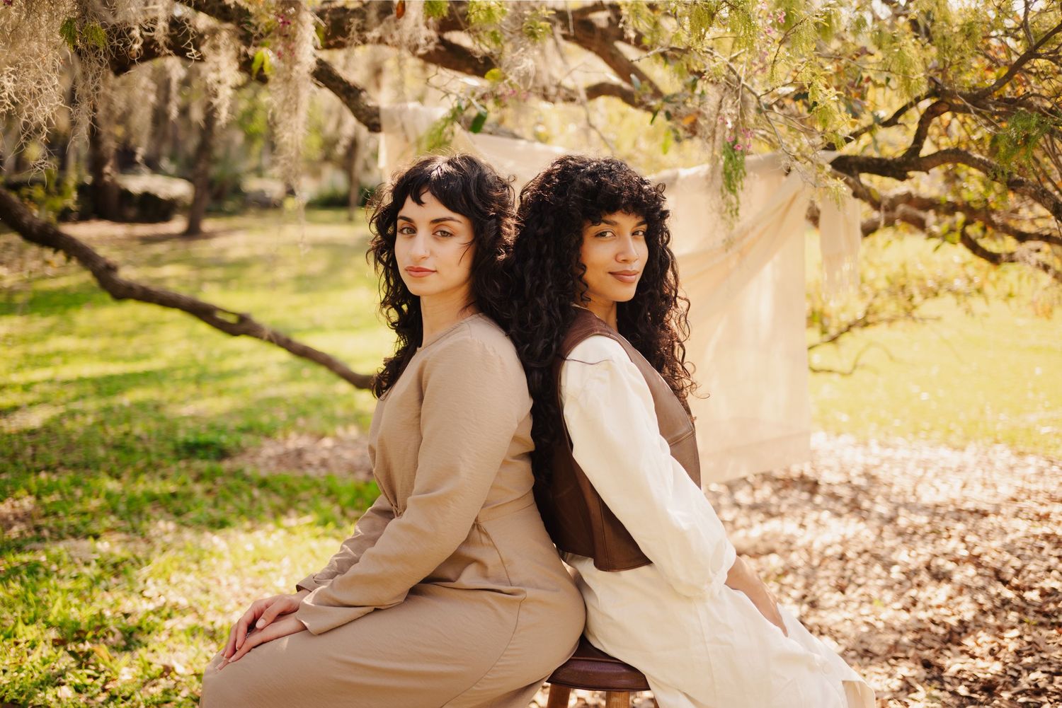 Artistic outdoor portrait series with muted earth tones and natural backdrop.