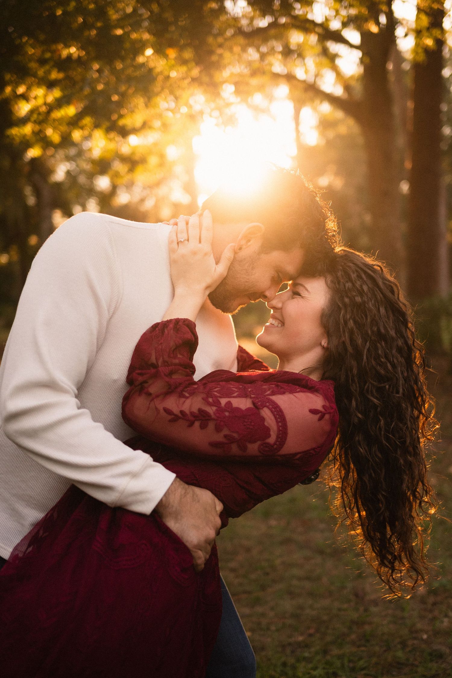 Romantic couple sharing intimate moment during golden hour photoshoot.