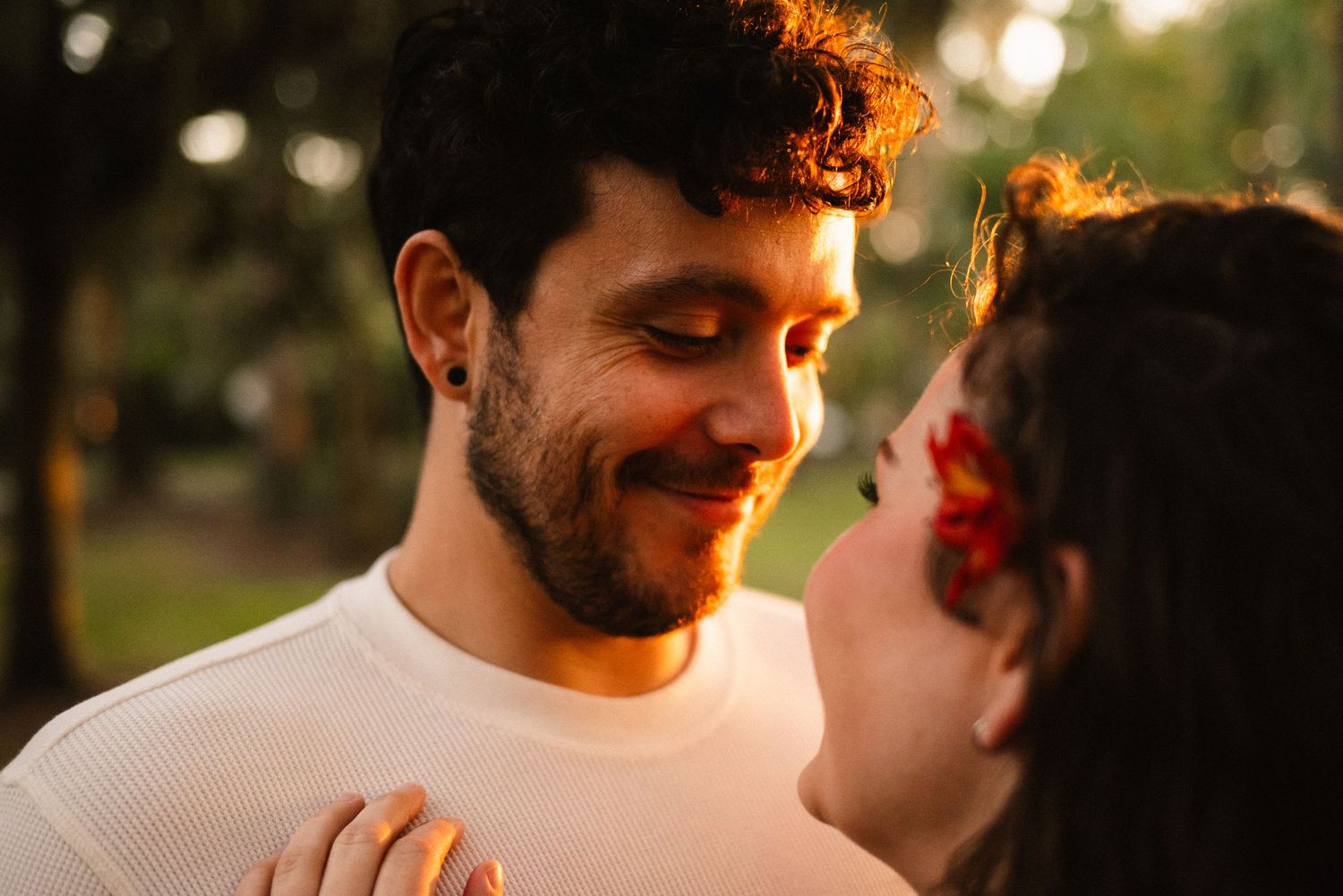 Intimate close-up shots of a couple during sunset with warm golden lighting.