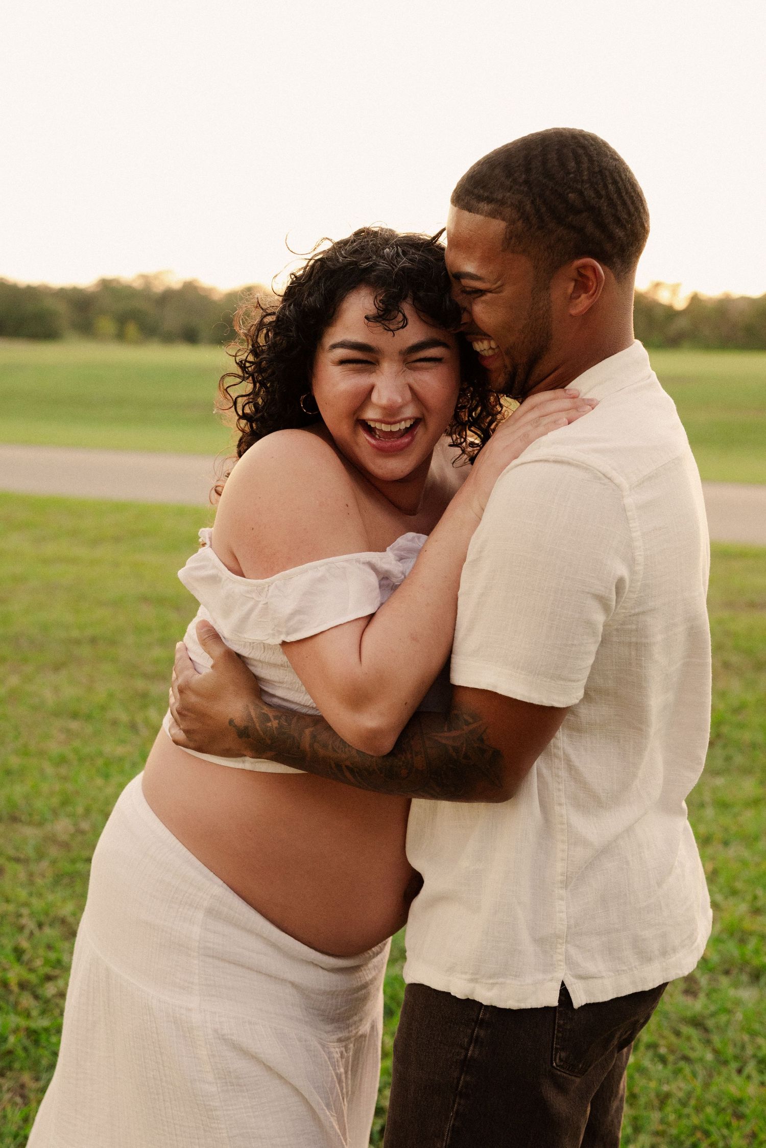 Joyful maternity session shows couple's natural chemistry and laughter.