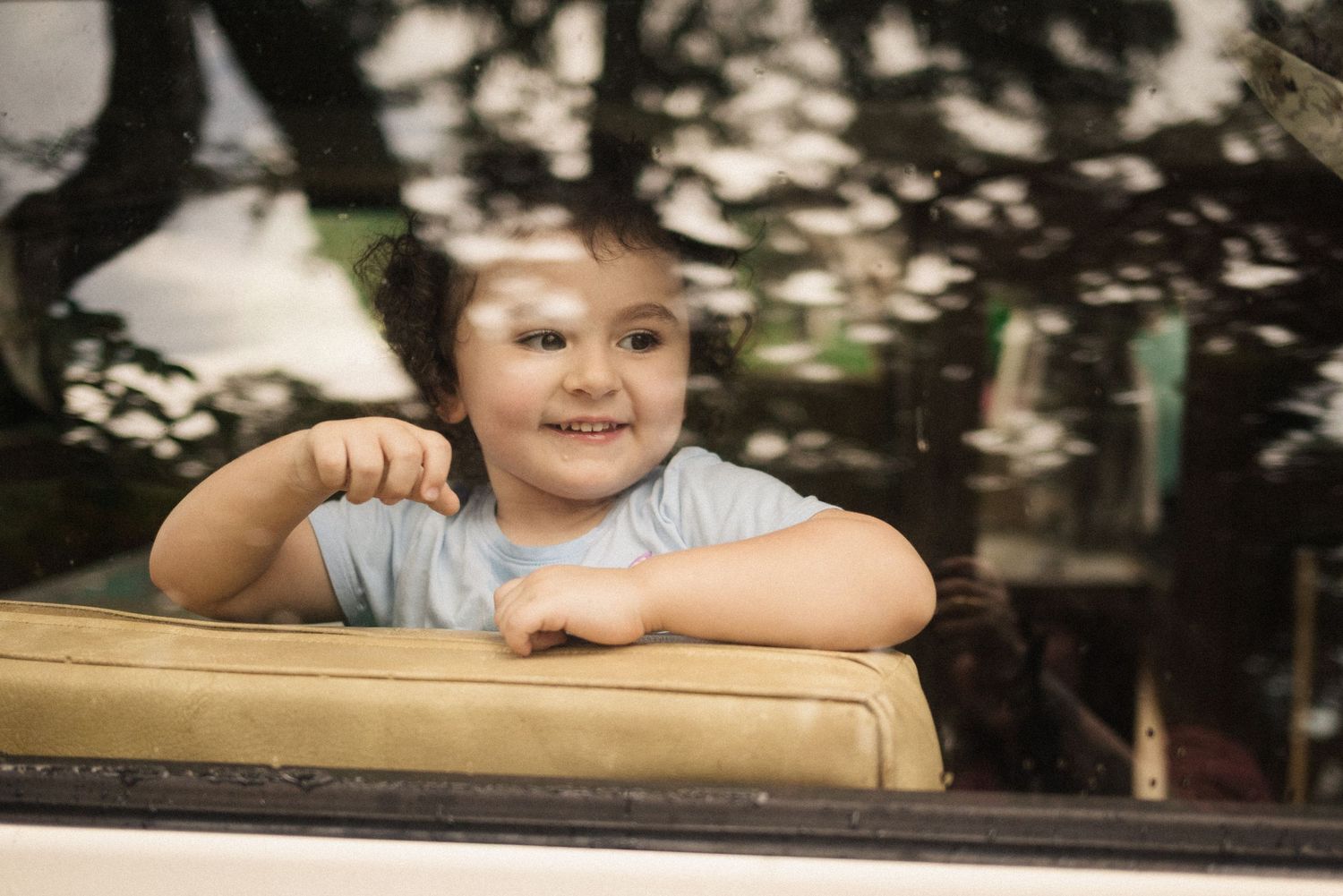 A series of black and white portraits showing joyful expressions and smiles.