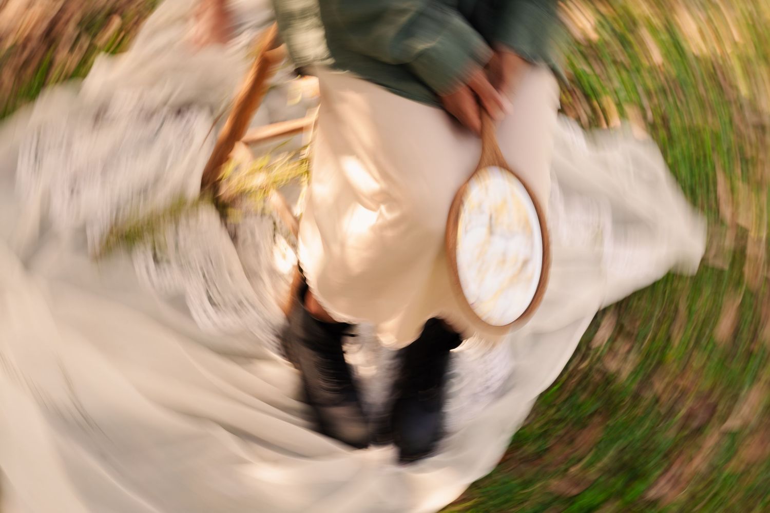 Creative spinning camera effect creates ethereal motion blur in outdoor portrait session.