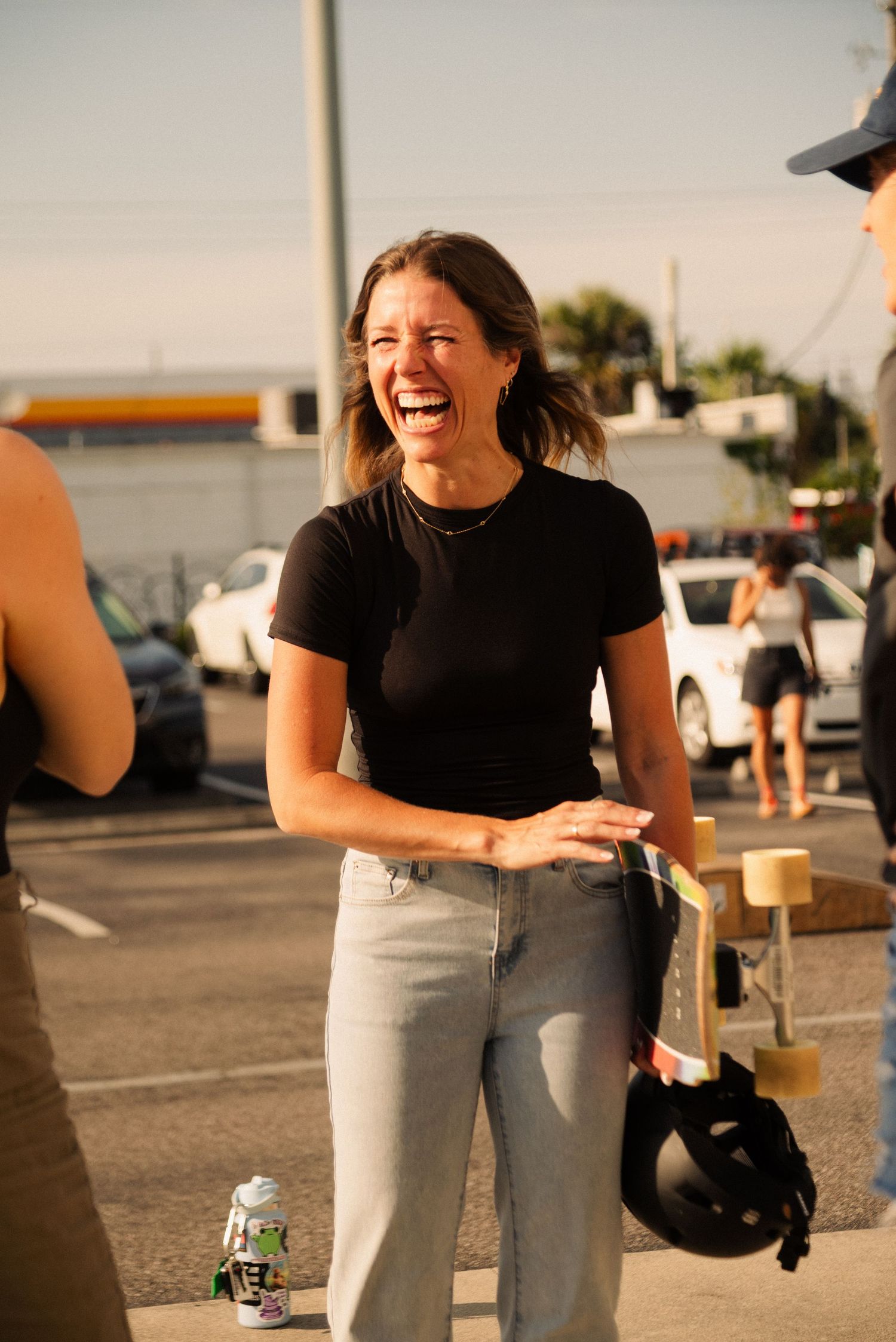 Casual outdoor skateboarding scene in a parking lot at golden hour.