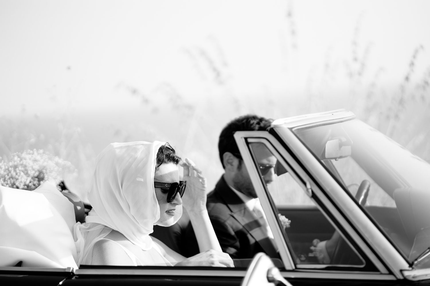 Luxury destination wedding in Calabria, elegant bride and groom in a vintage car captured in fine art editorial style