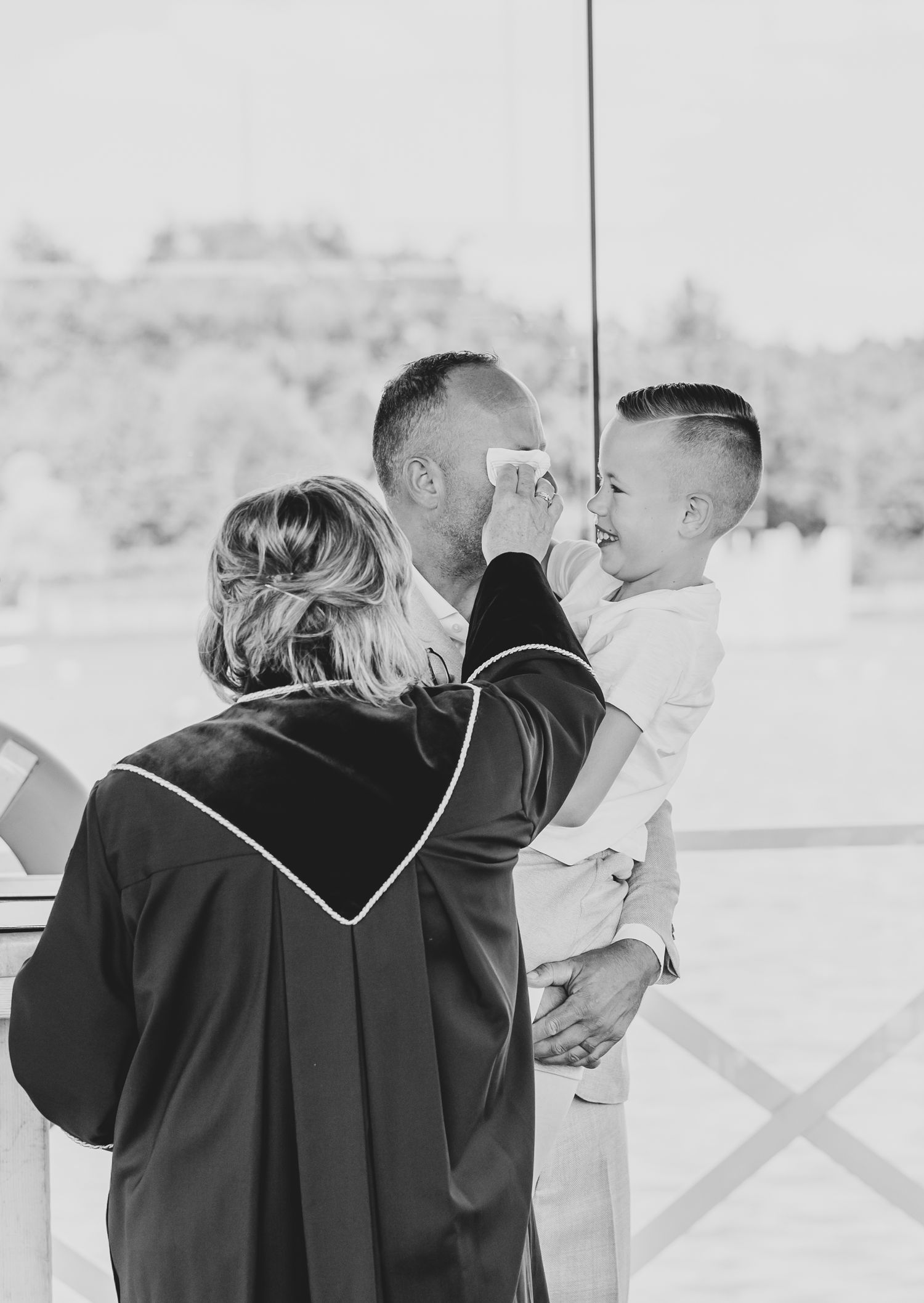 A tender moment between parent and child at a graduation ceremony.