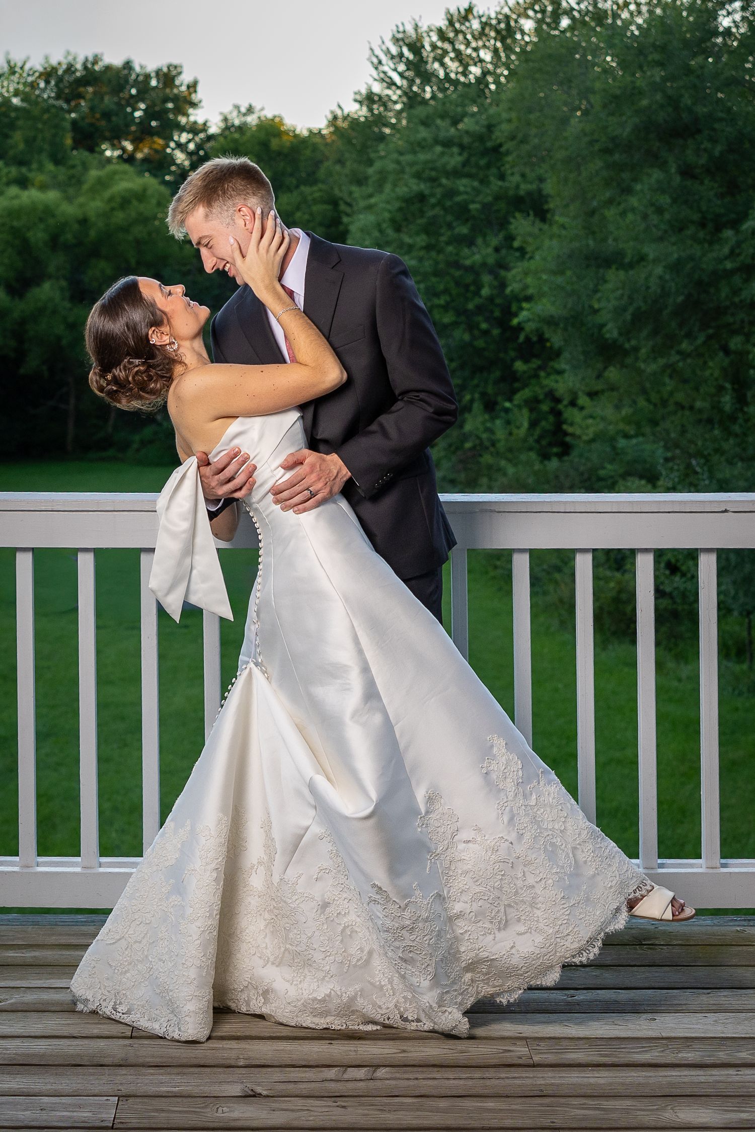 Bride and groom taking sunset photos after the Sacrament of Holy Matrimony at a Catholic church.