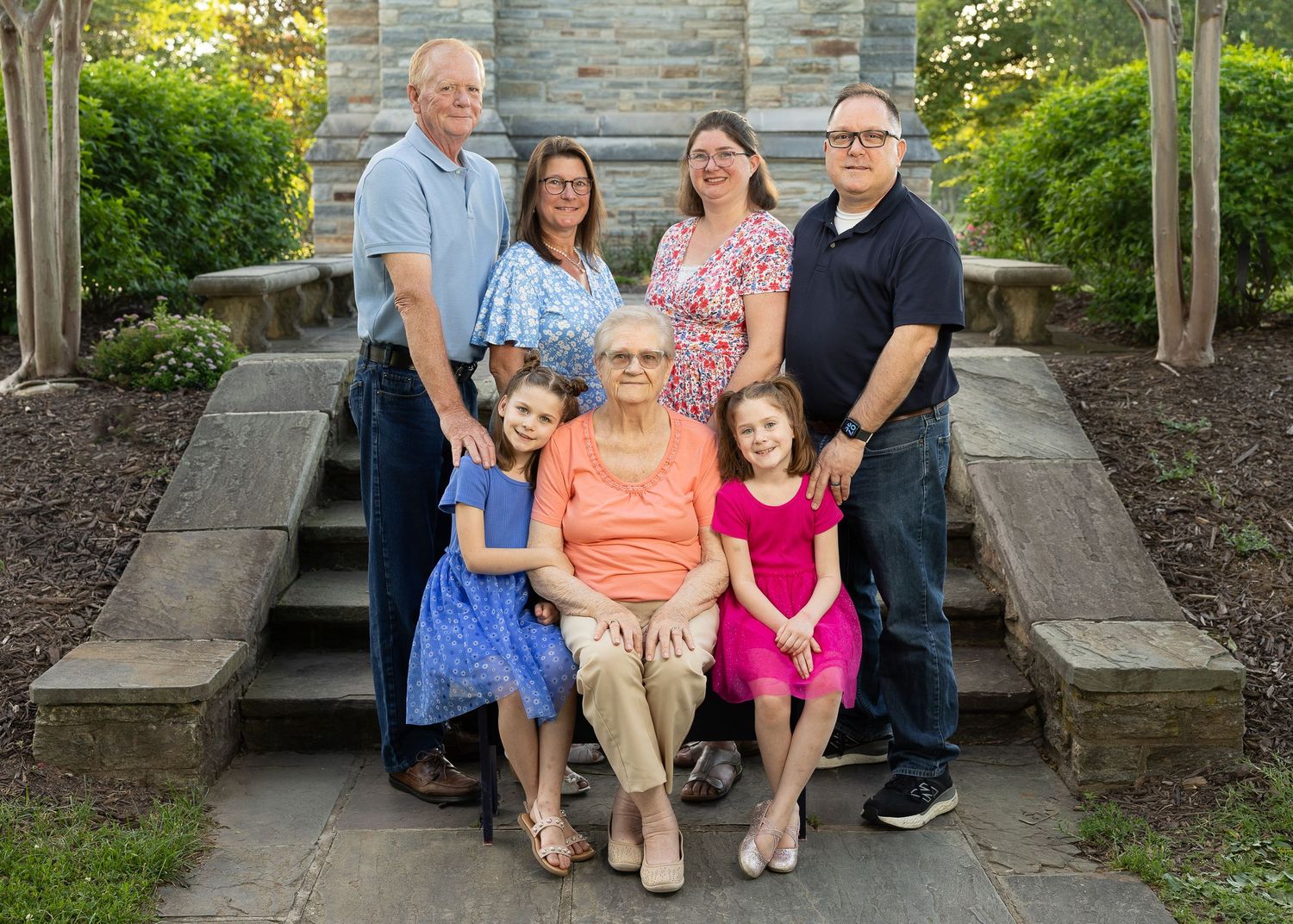 A happy family standing together during a golden hour photography session.