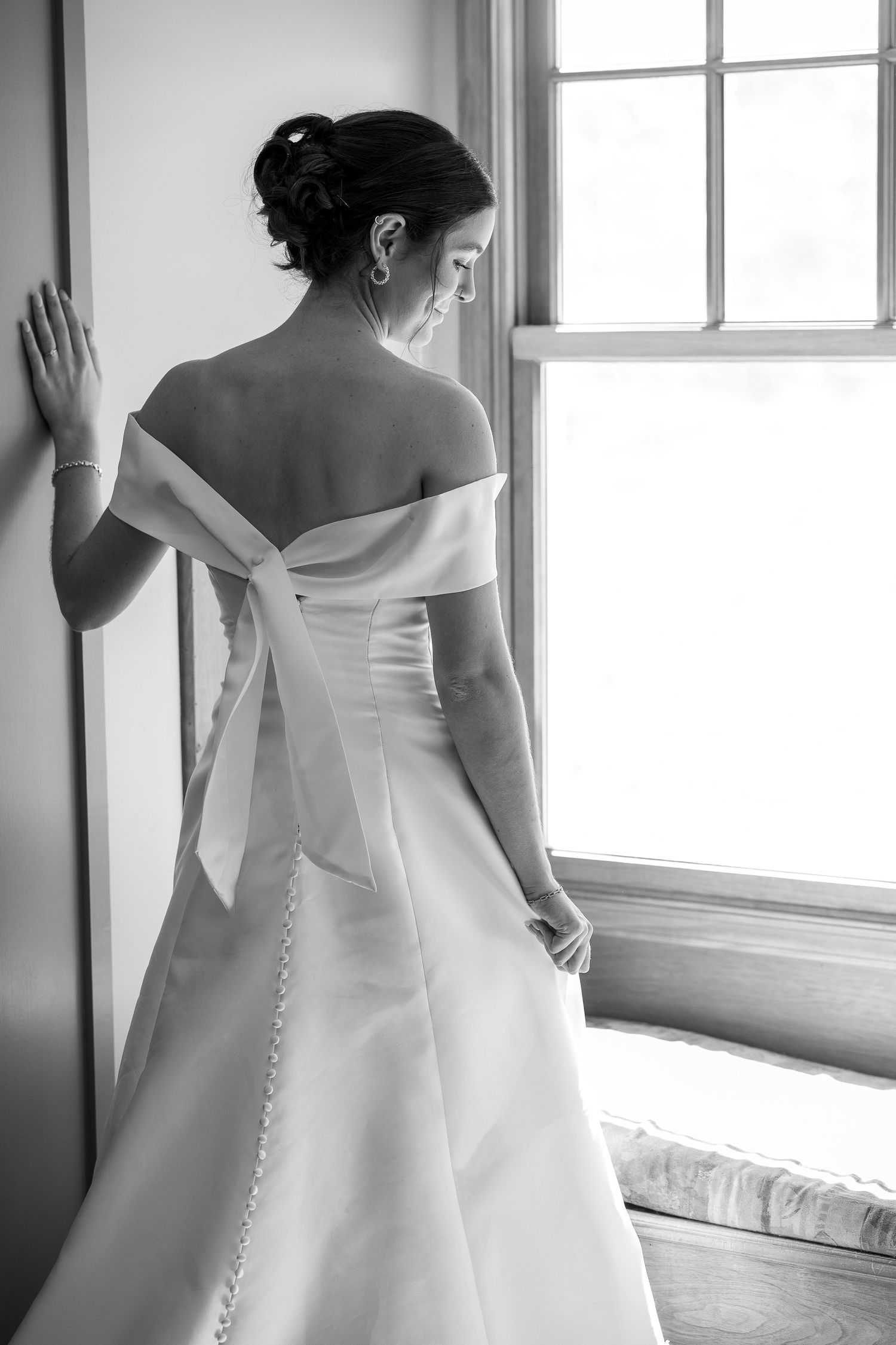 A beautiful bride standing and smiling before the Sacrament of Holy Matrimony at a Catholic church.