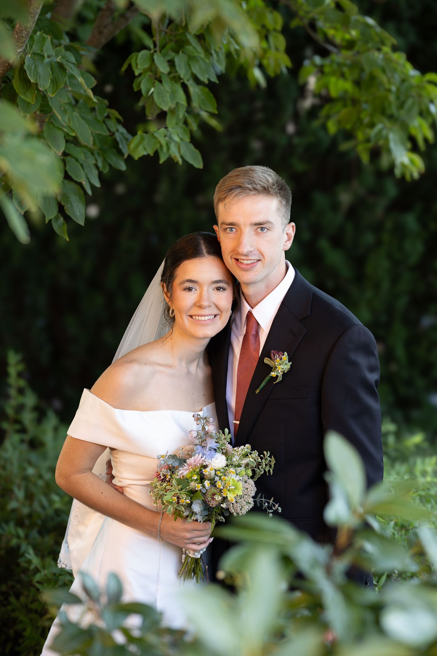 Bride and groom taking bridal portraits after the Sacrament of Holy Matrimony at a Catholic church.
