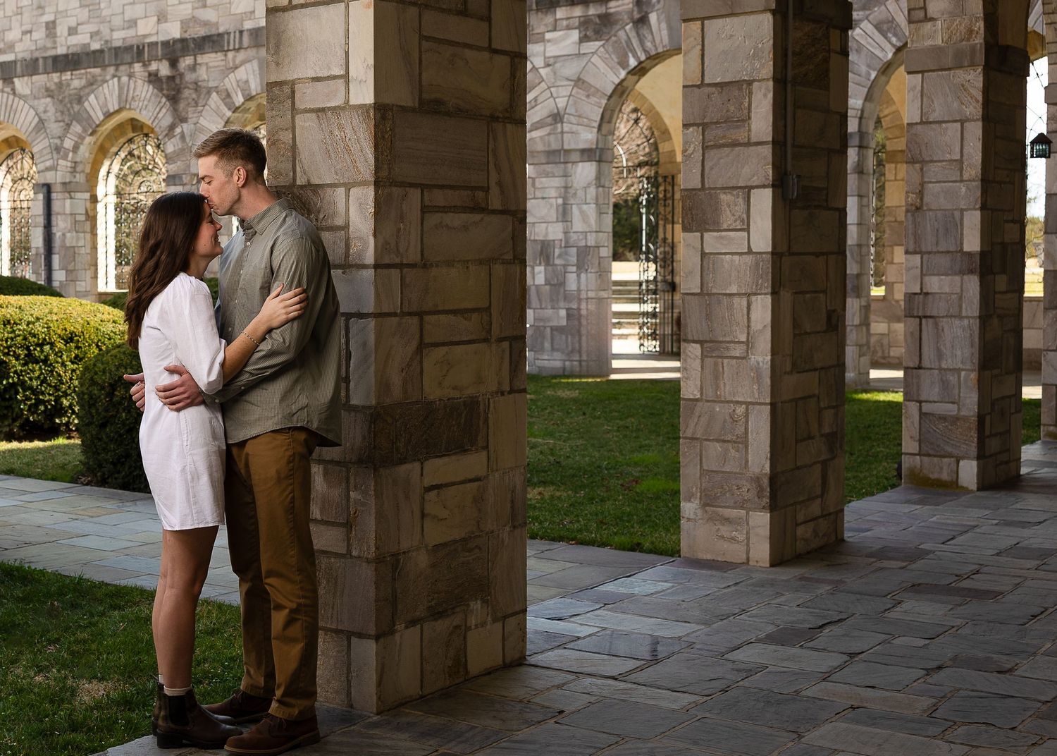 A newly engaged couple laughing together during a golden hour engagement photography session.