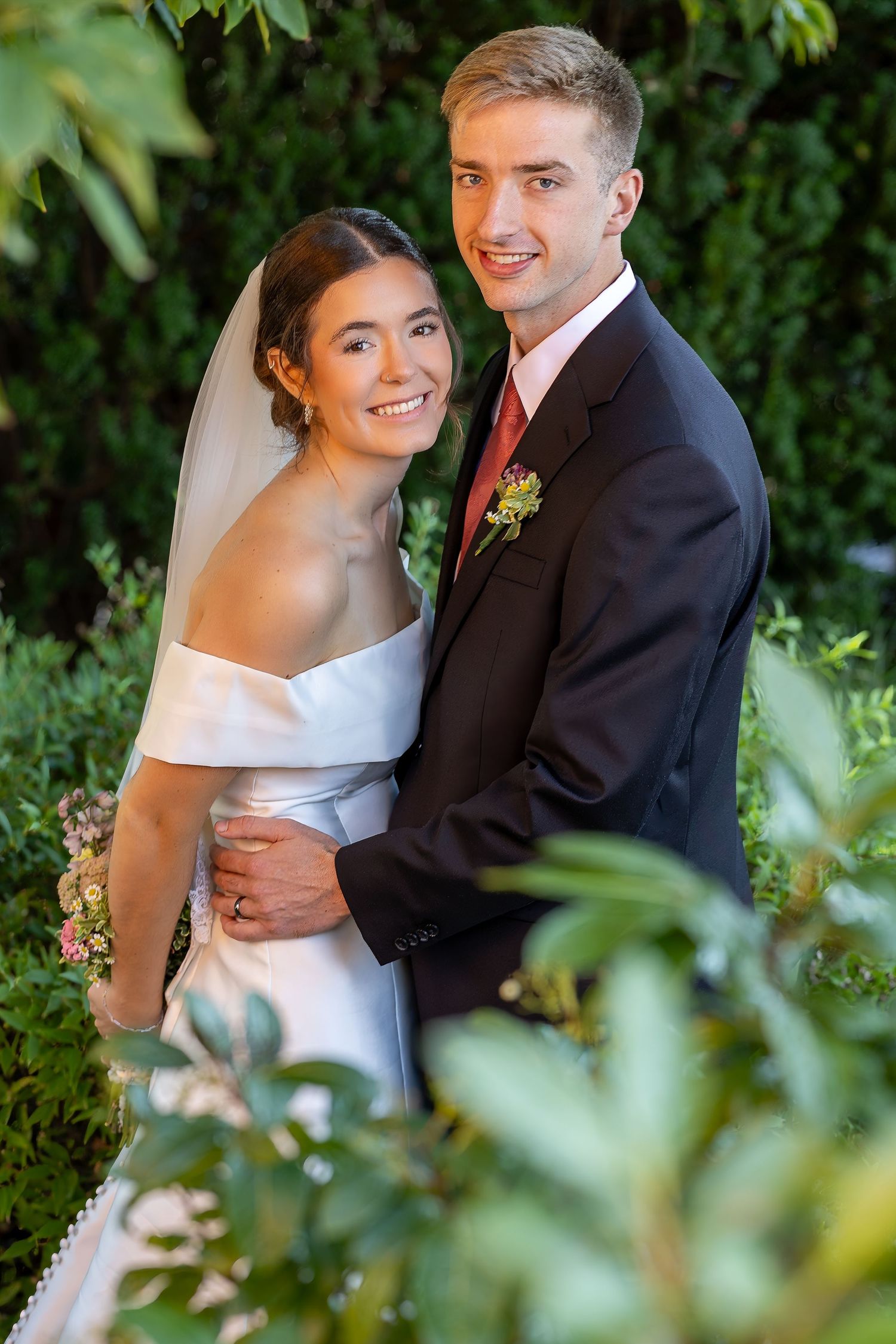 Bride and groom taking bridal portraits after the Sacrament of Holy Matrimony at a Catholic church.