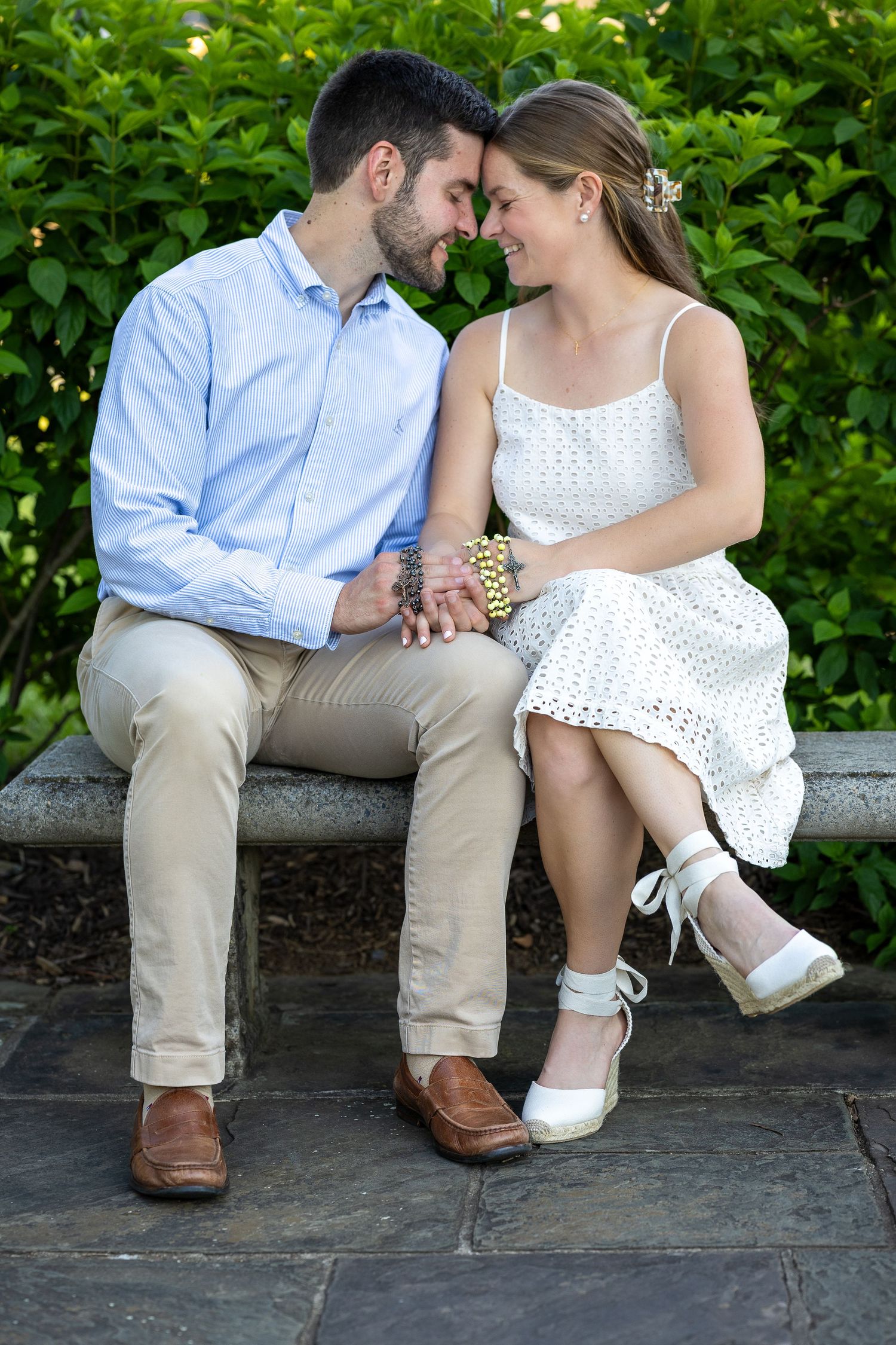 A newly engaged couple sitting together during a golden hour engagement photography session.