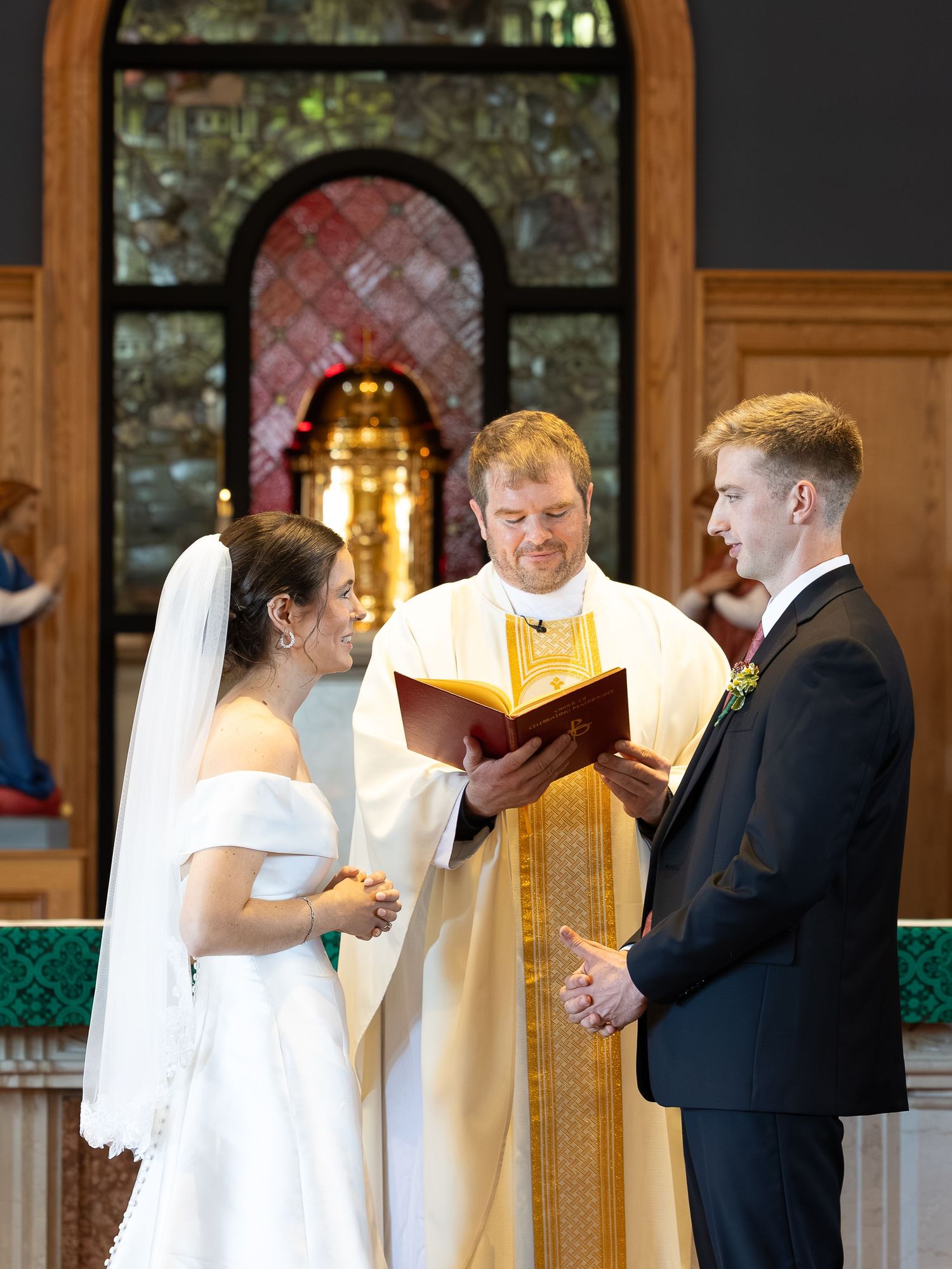 Bride and groom exchanging rings during the Sacrament of Holy Matrimony.