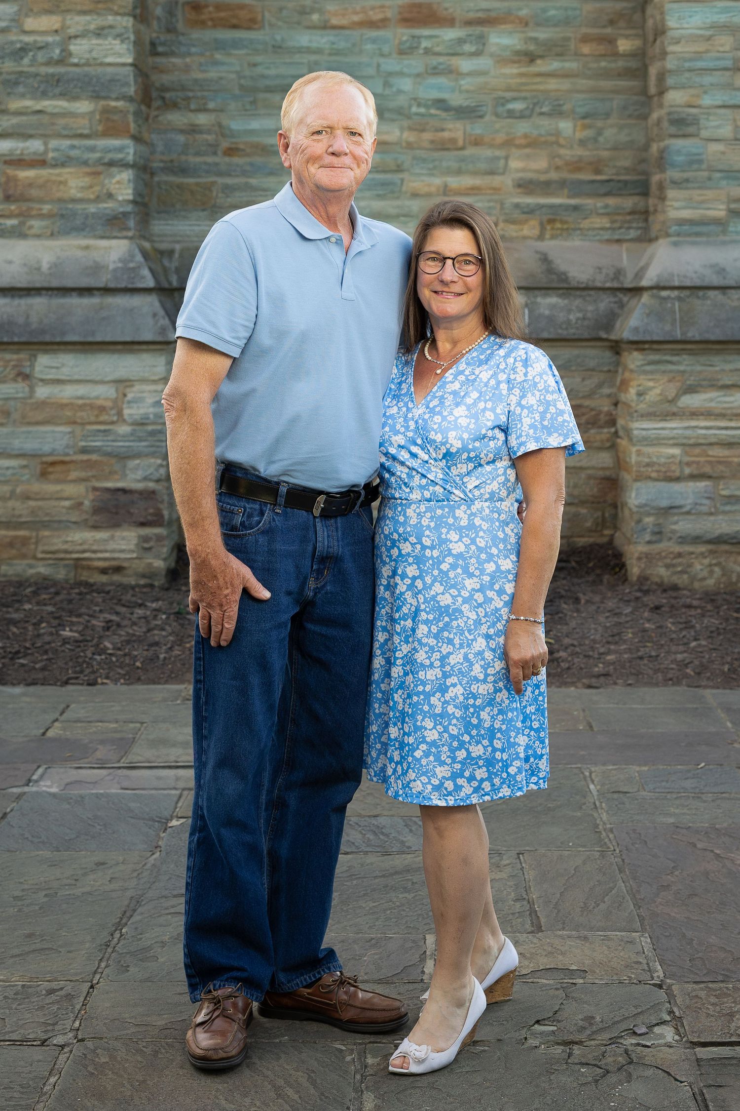 A happy family standing together during a golden hour photography session.