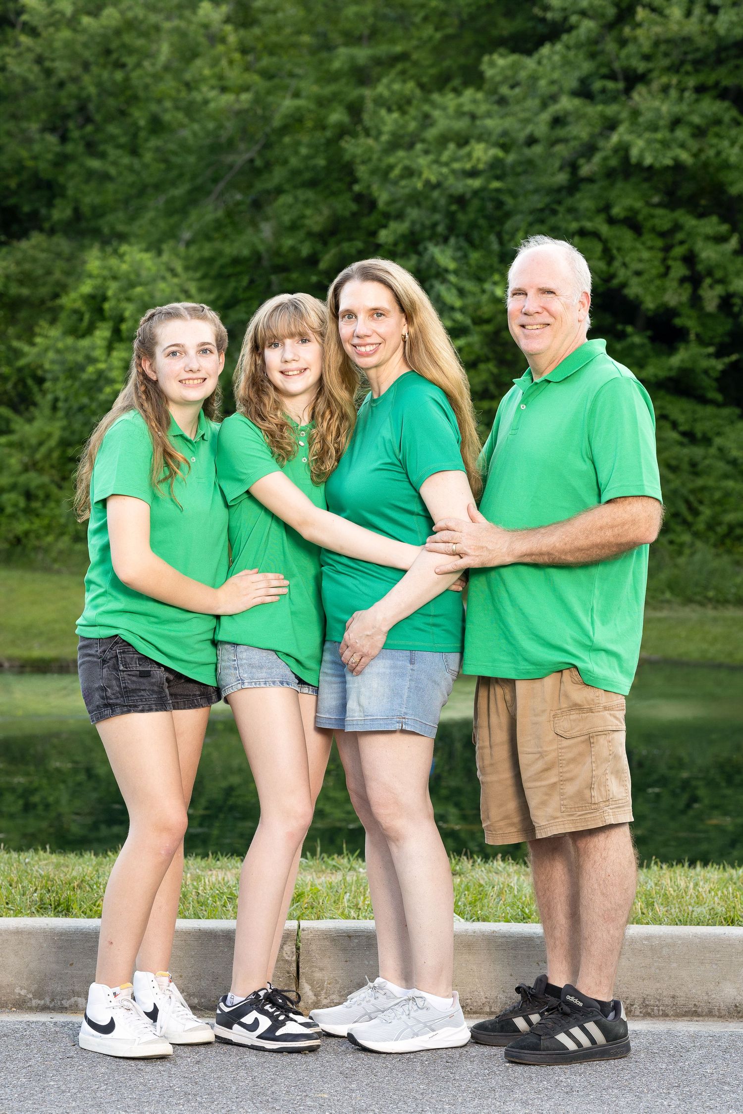 A happy family standing together during a golden hour photography session.