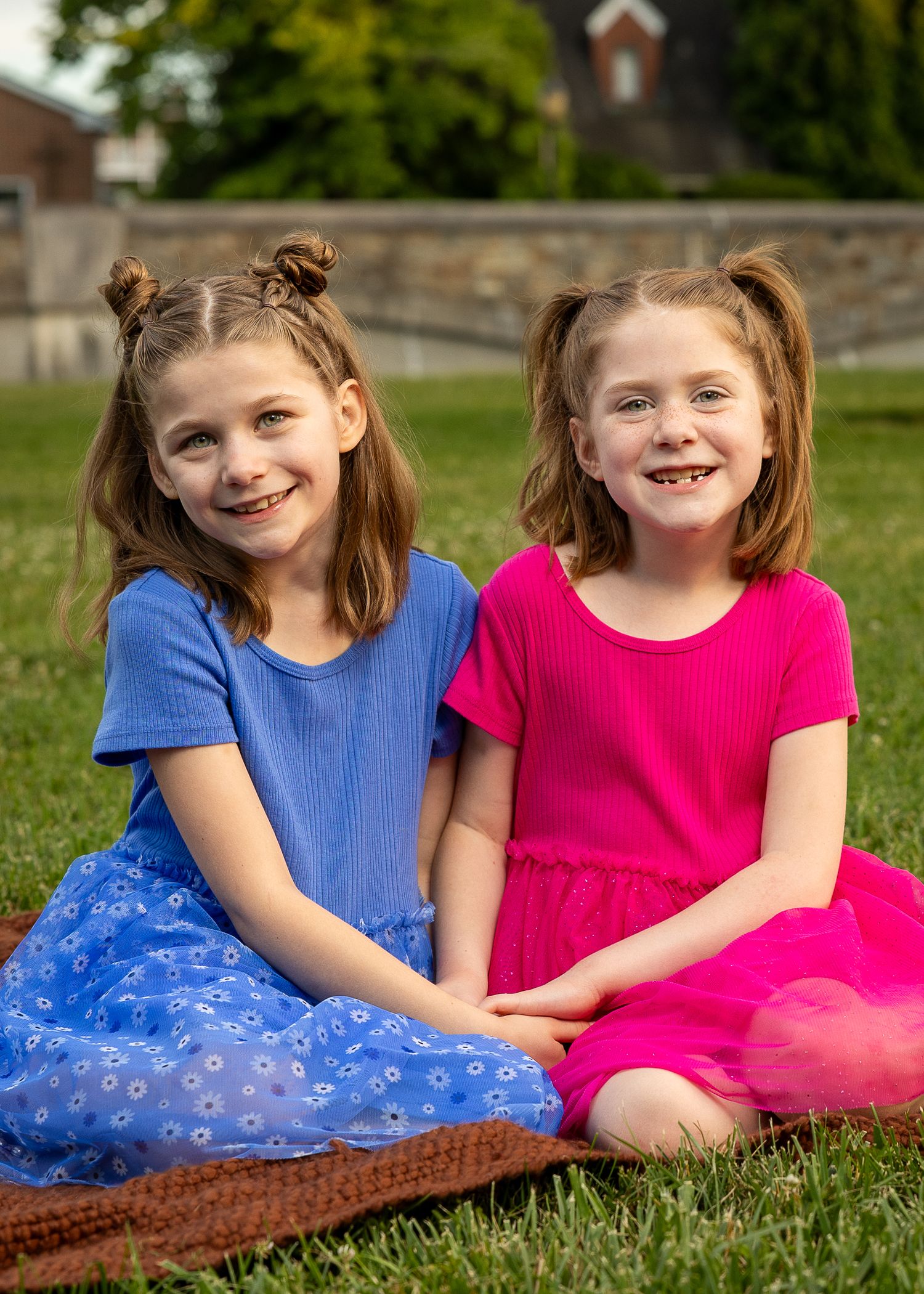 A happy family sitting together during a golden hour photography session.