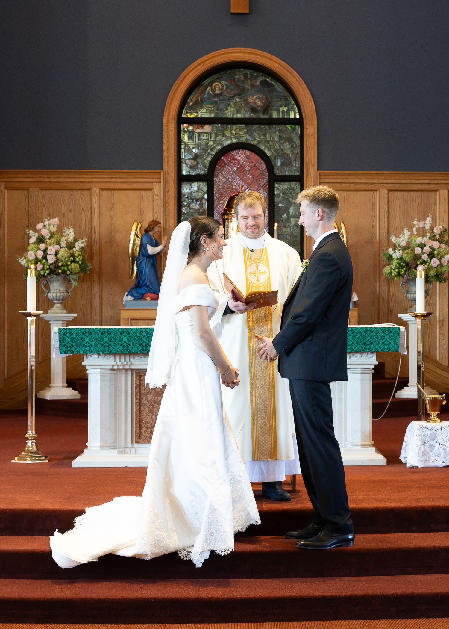 Bride and groom exchanging rings during the Sacrament of Holy Matrimony.