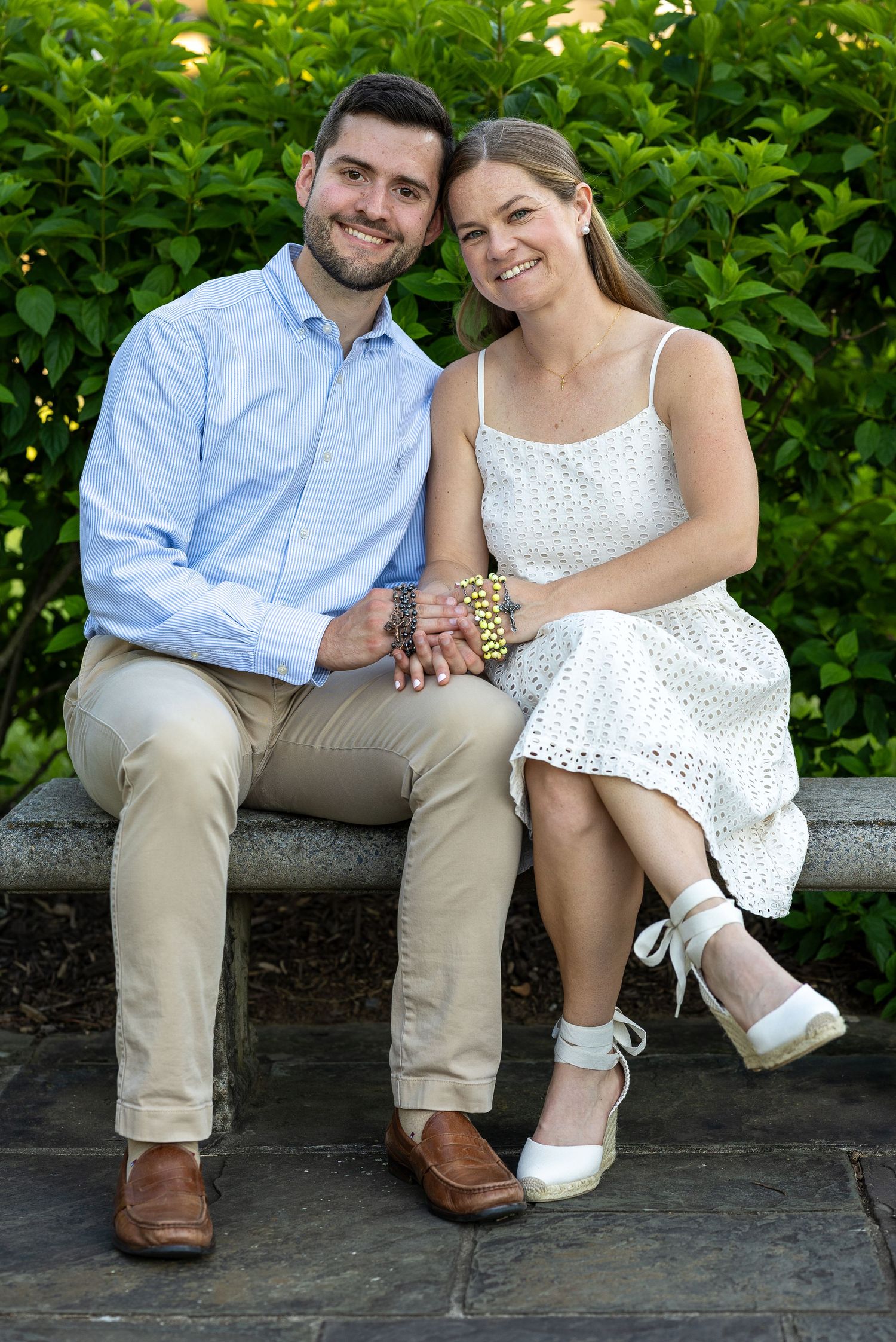 A newly engaged couple sitting together during a golden hour engagement photography session.