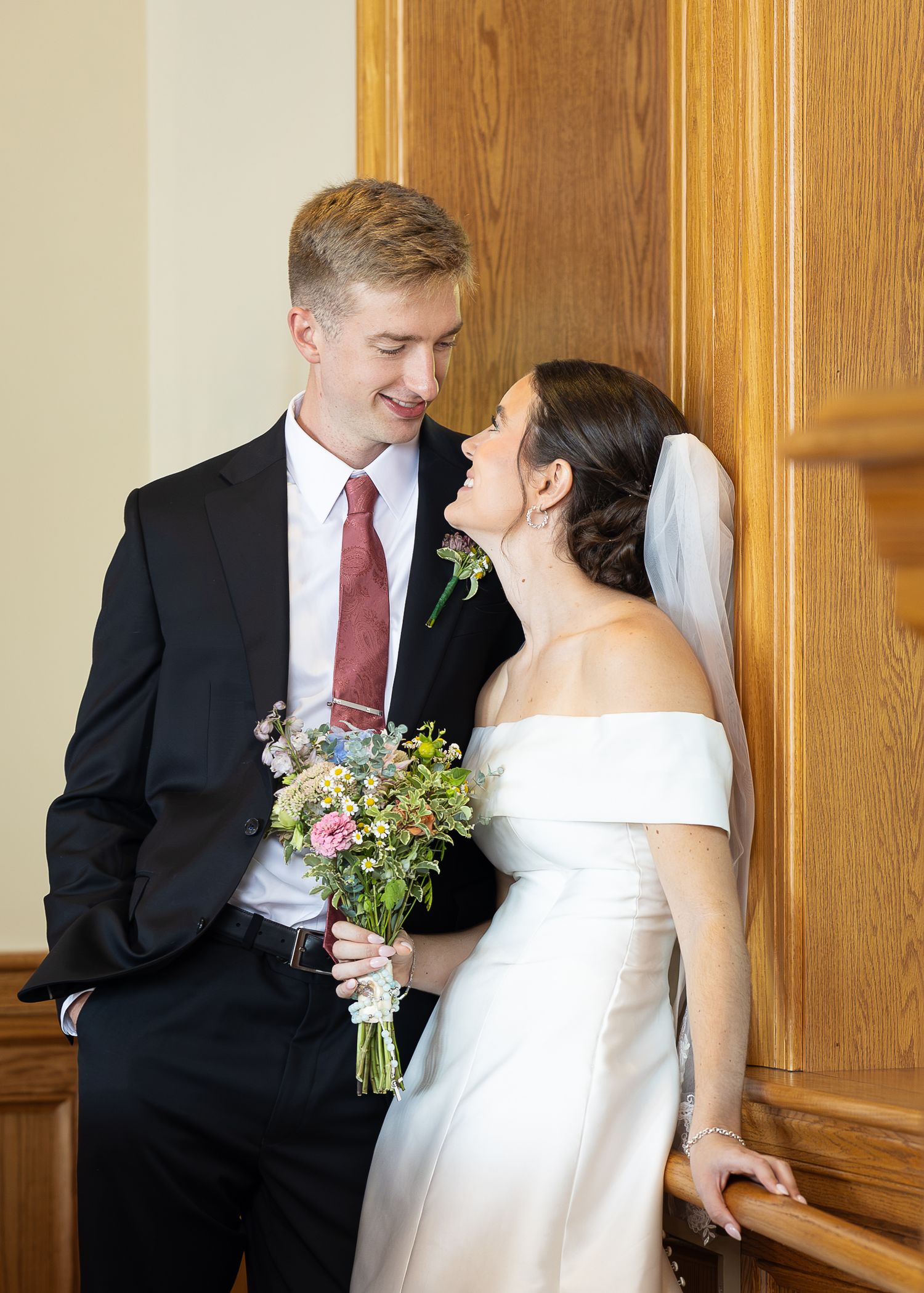 Bride and groom taking bridal portraits after the Sacrament of Holy Matrimony at a Catholic church.