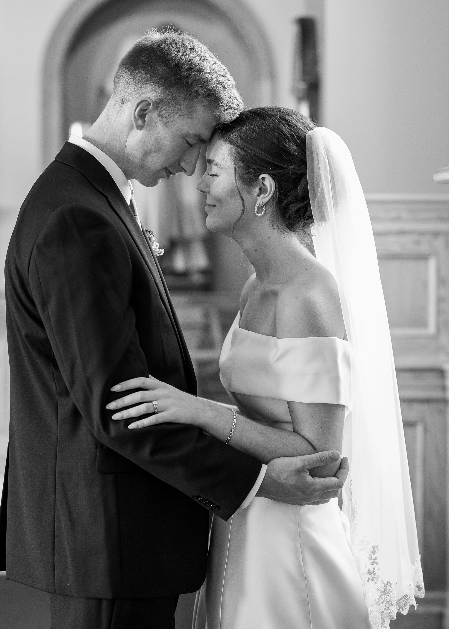 Bride and groom taking bridal portraits after the Sacrament of Holy Matrimony at a Catholic church.