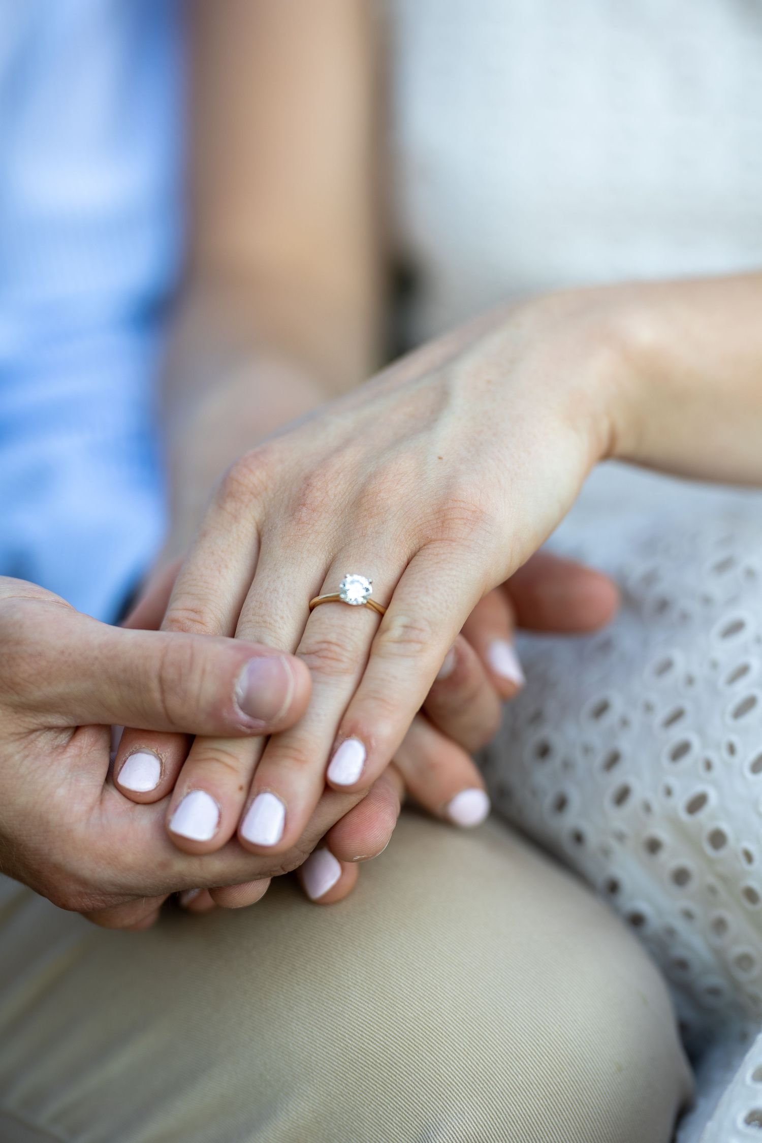 A newly engaged couple laughing together during a golden hour engagement photography session.