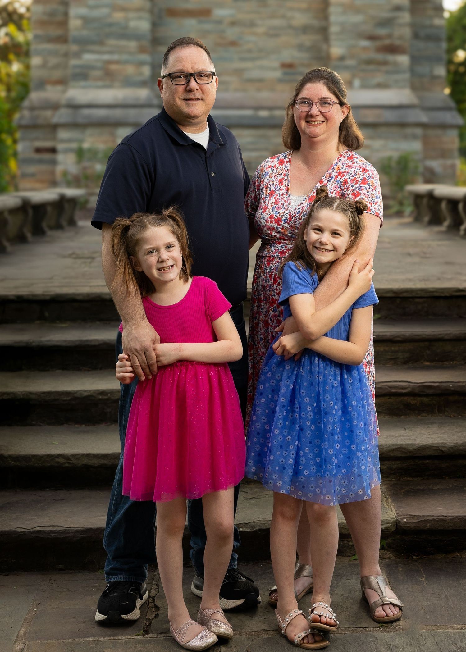 A happy family standing together during a golden hour photography session.