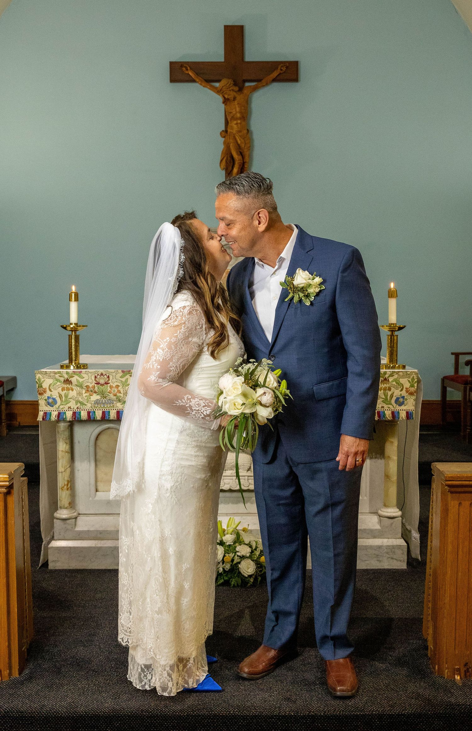 Bride and groom taking bridal portraits after the Sacrament of Holy Matrimony at a C   atholic church.