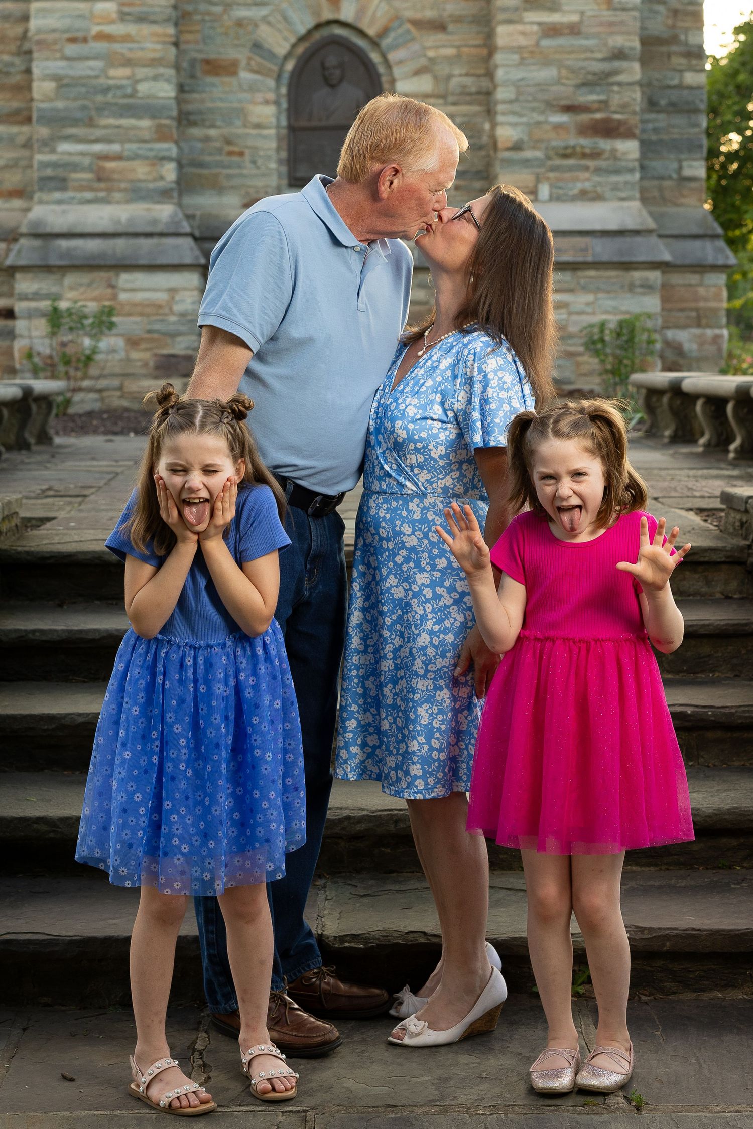 A happy family standing together during a golden hour photography session.