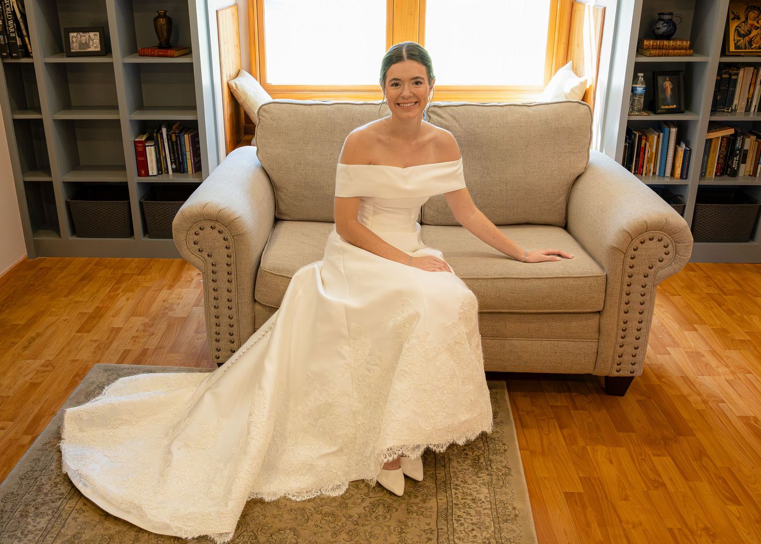 A beautiful bride sitting and smiling before the Sacrament of Holy Matrimony at a Catholic church.