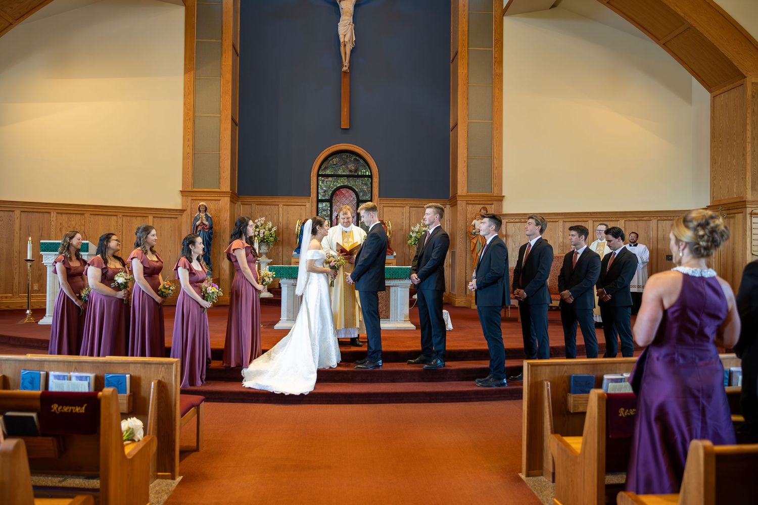 Bride and groom exchanging rings during the Sacrament of Holy Matrimony.