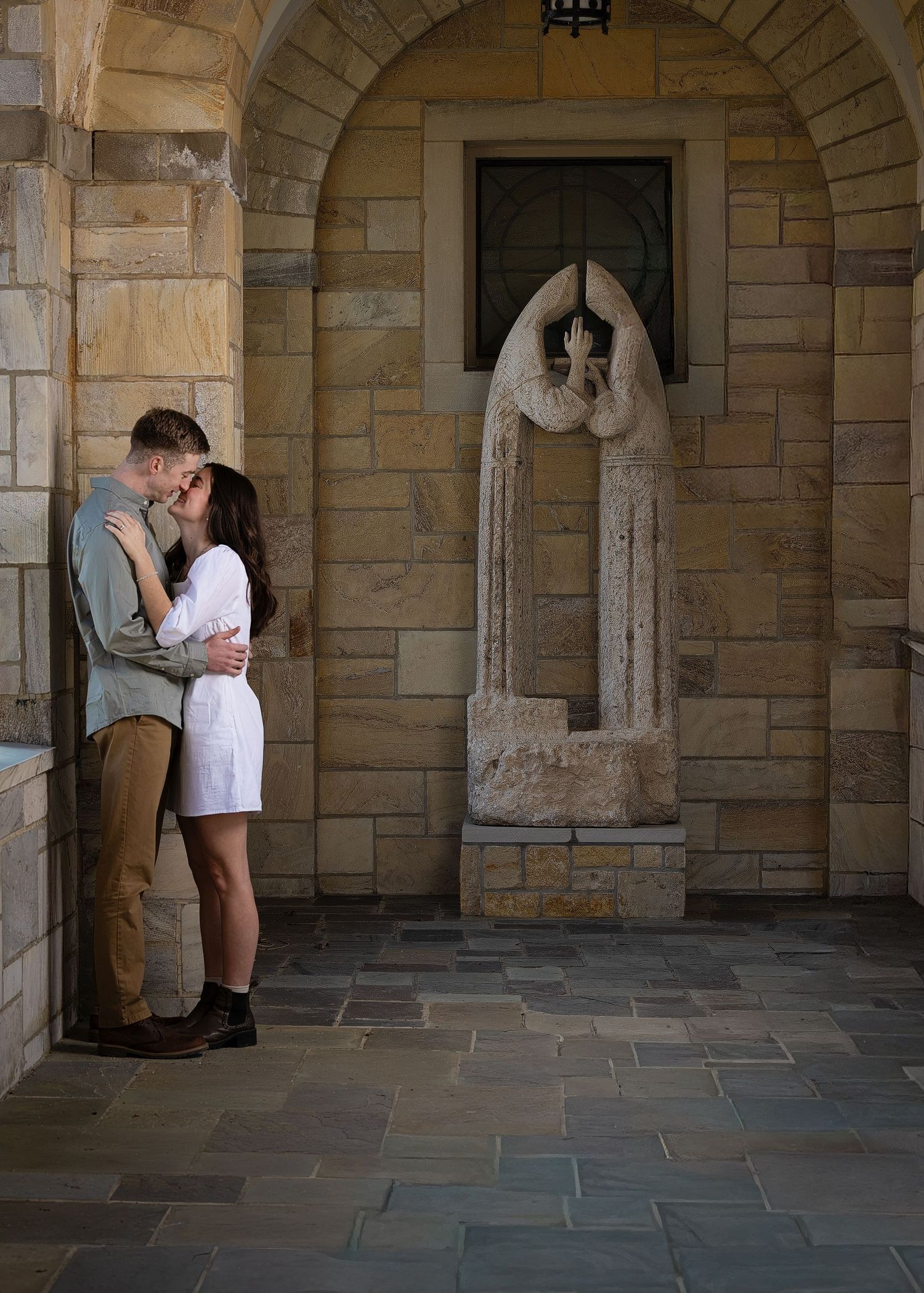 A newly engaged couple laughing together during a golden hour engagement photography session.