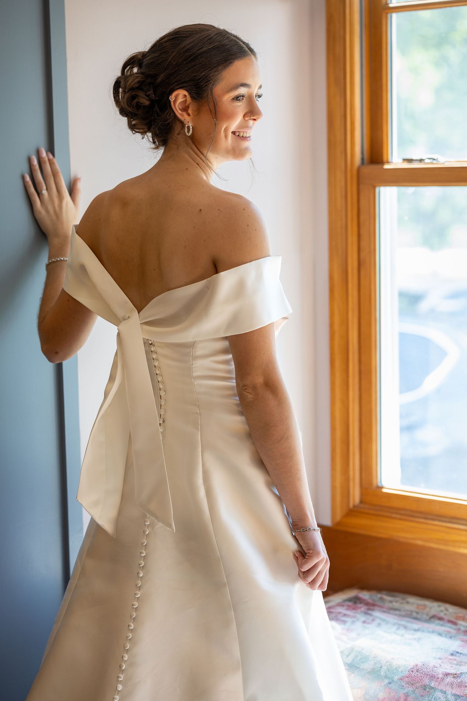 A beautiful bride standing and smiling before the Sacrament of Holy Matrimony at a Catholic church.