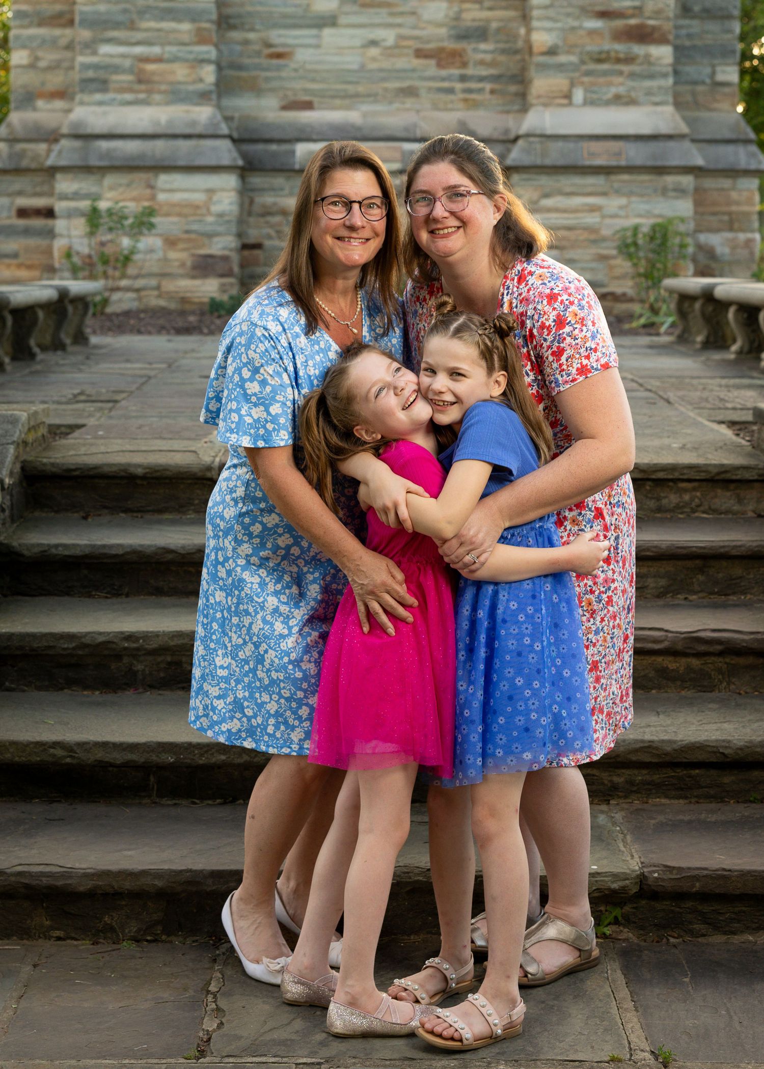A happy family standing together during a golden hour photography session.