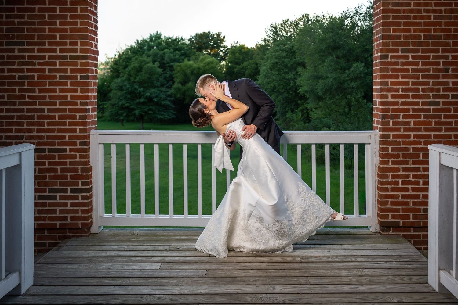 Bride and groom taking bridal portraits after the Sacrament of Holy Matrimony at a Catholic church.